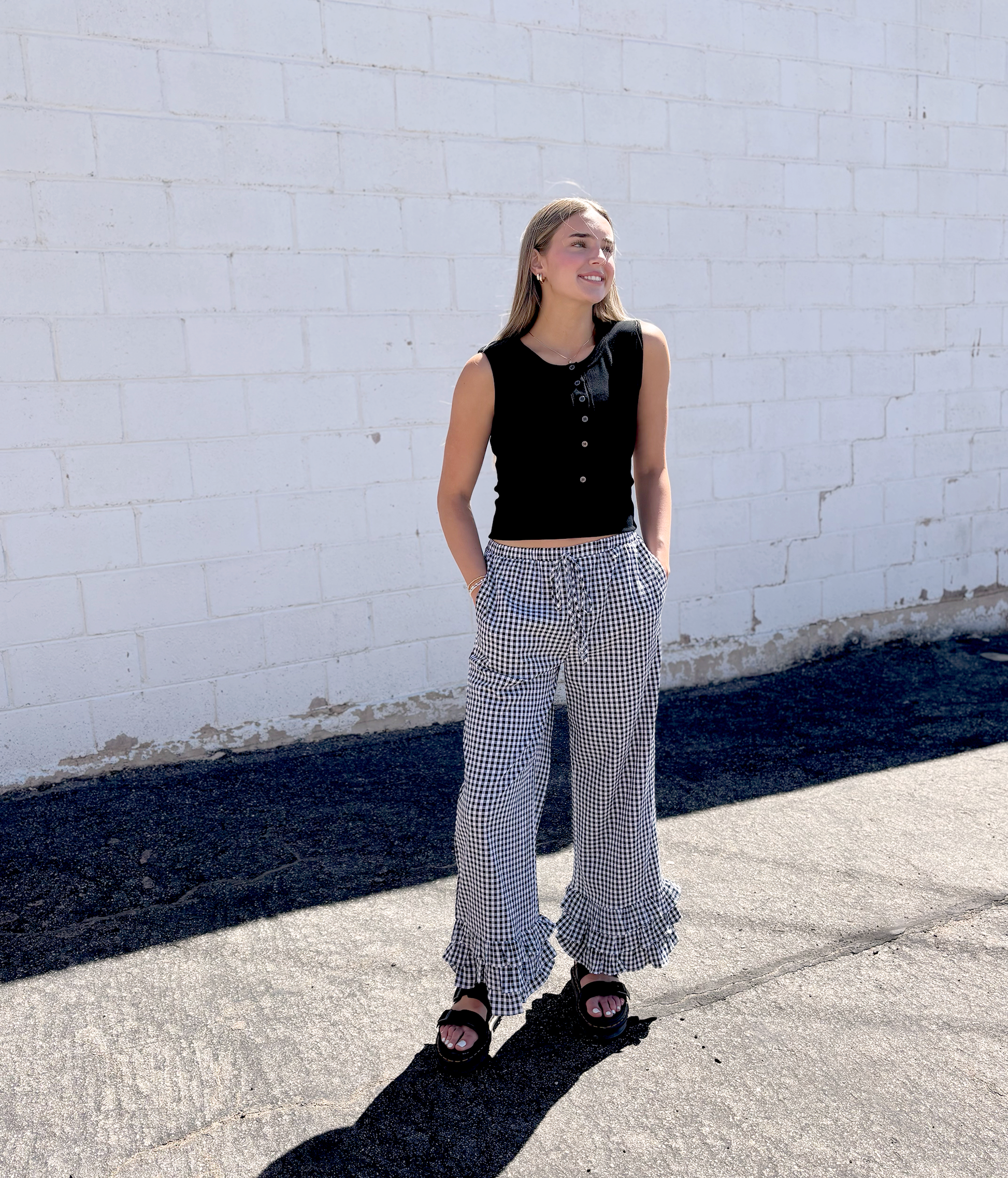 Black and white gingham pants with ruffles along the bottom of each leg