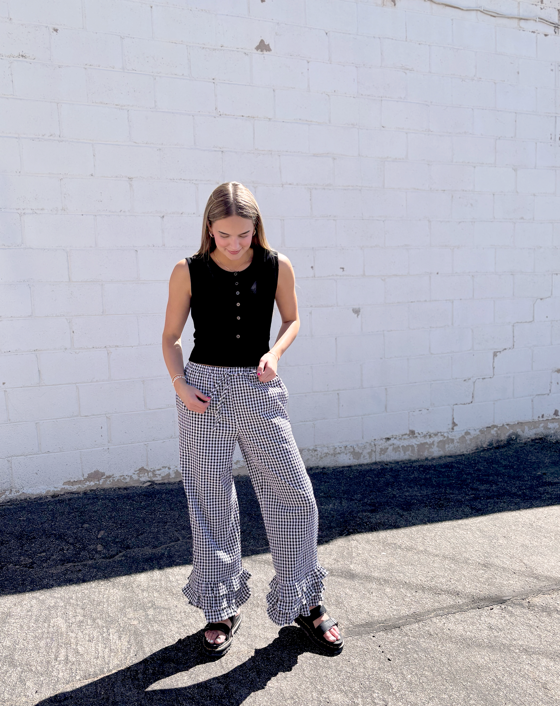 Black and white gingham pants with ruffles along the bottom of each leg