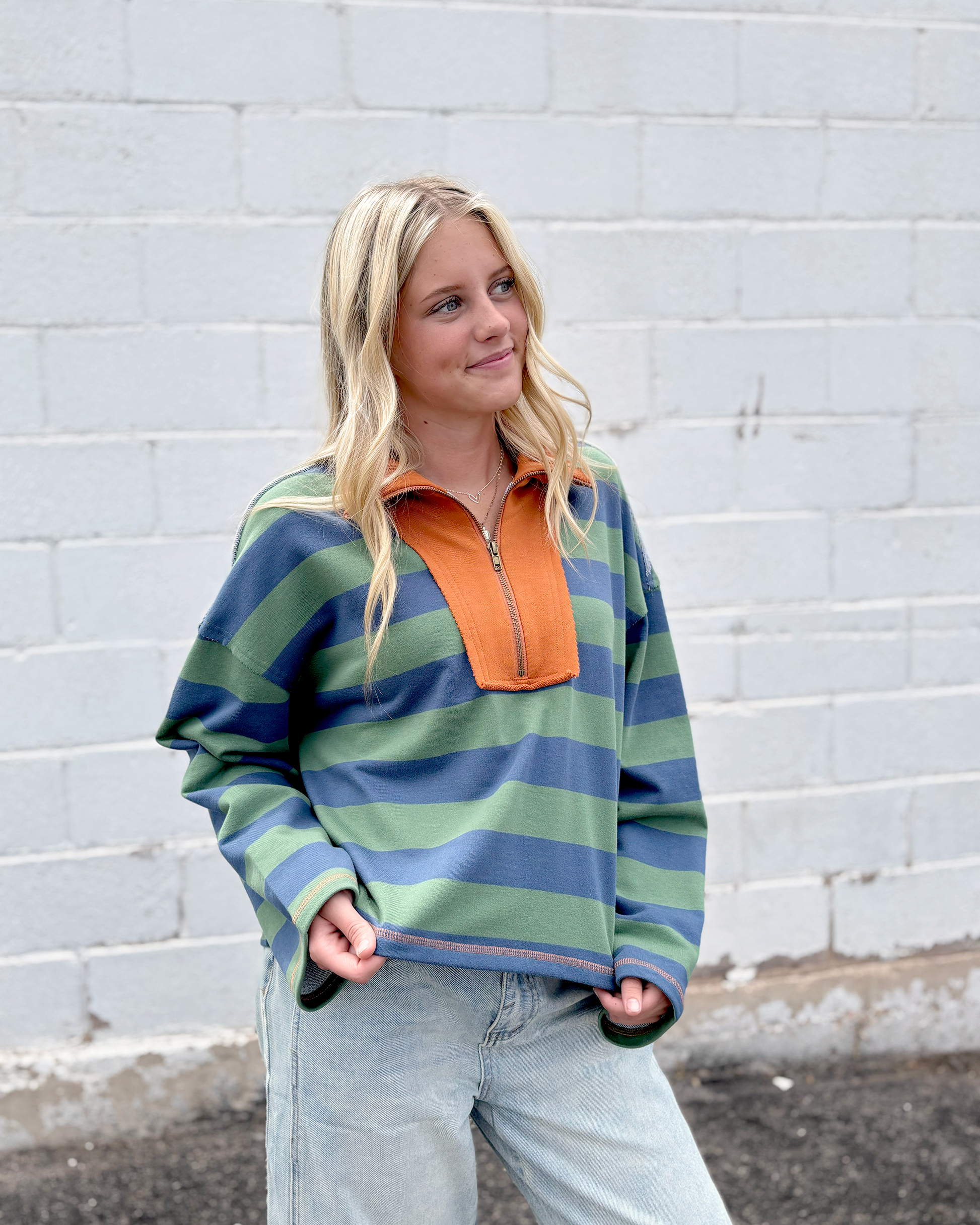 Green and blue striped half zip sweater