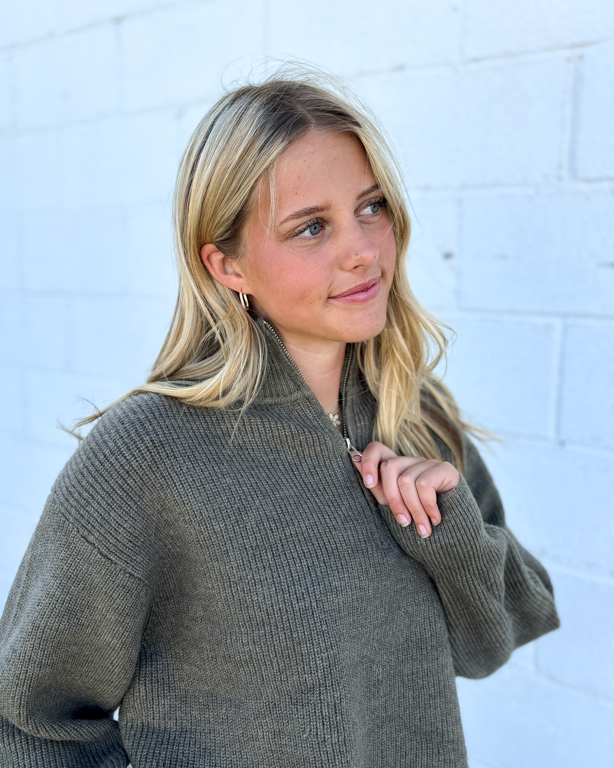 grey green sweater with long sleeves and half zip