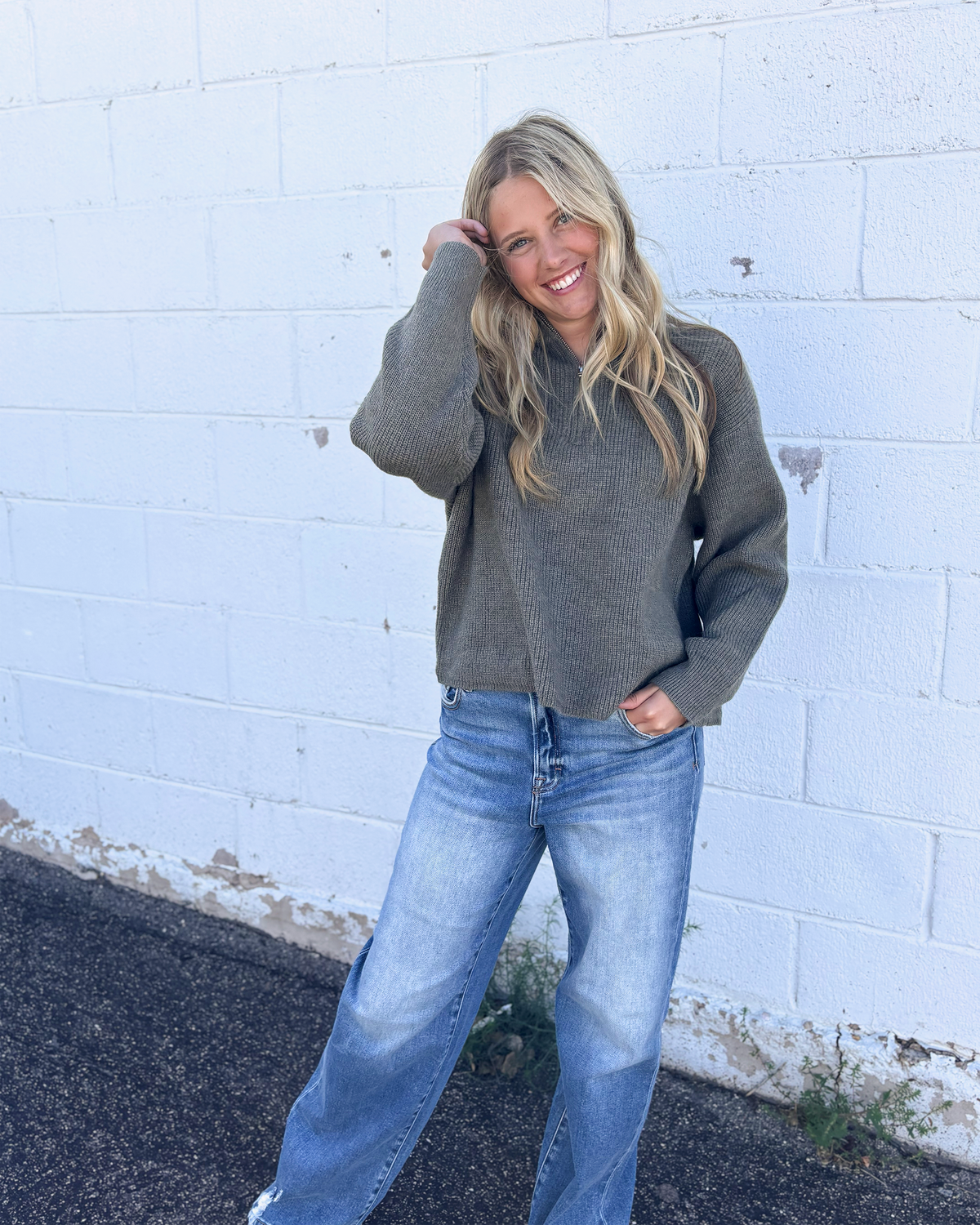 grey green sweater with long sleeves and half zip