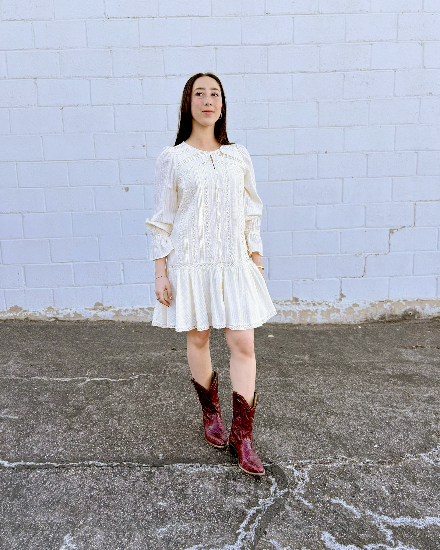 Ivory long sleeve short dress with lace details and a drop waist 