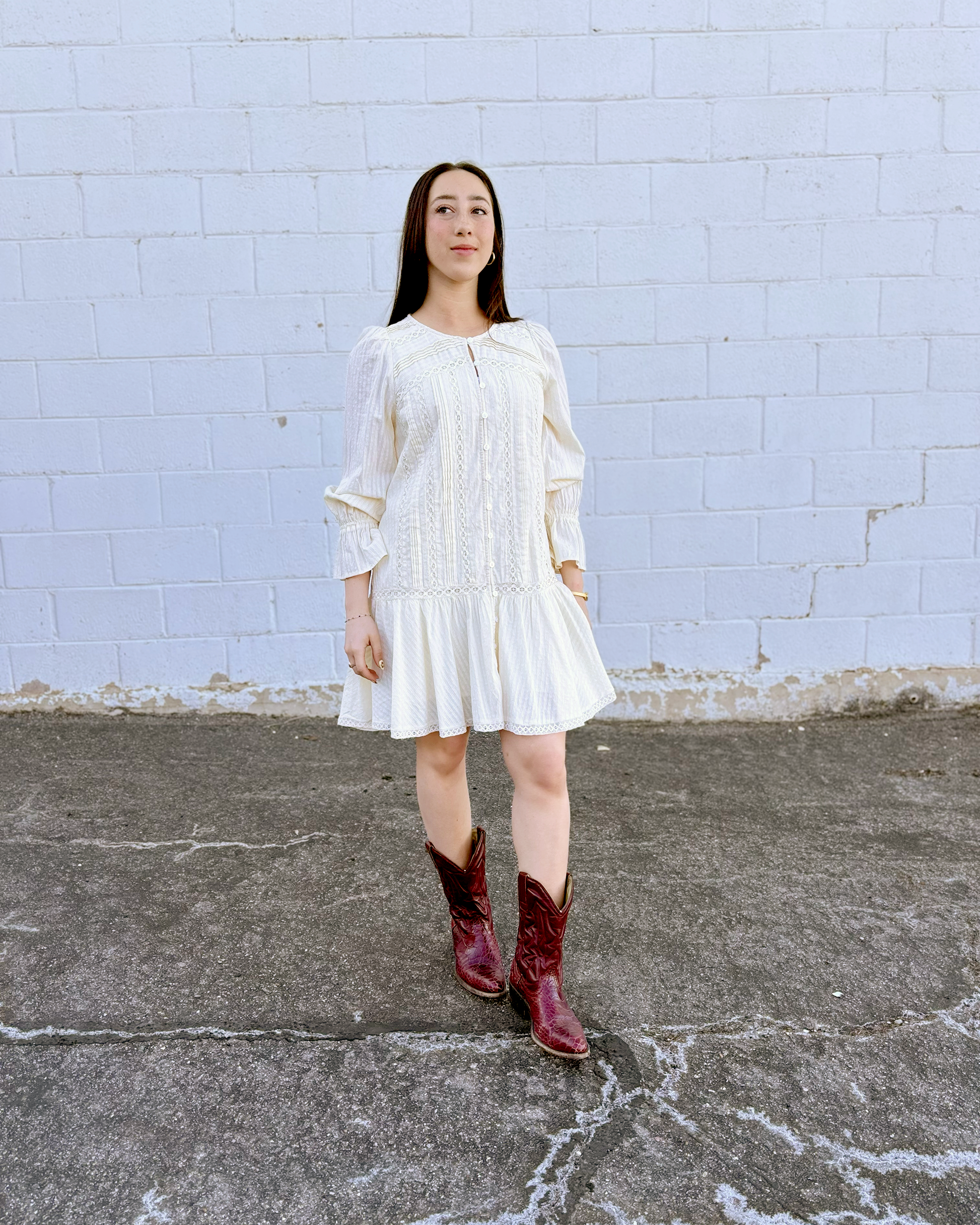 Ivory long sleeve short dress with lace details and a drop waist 