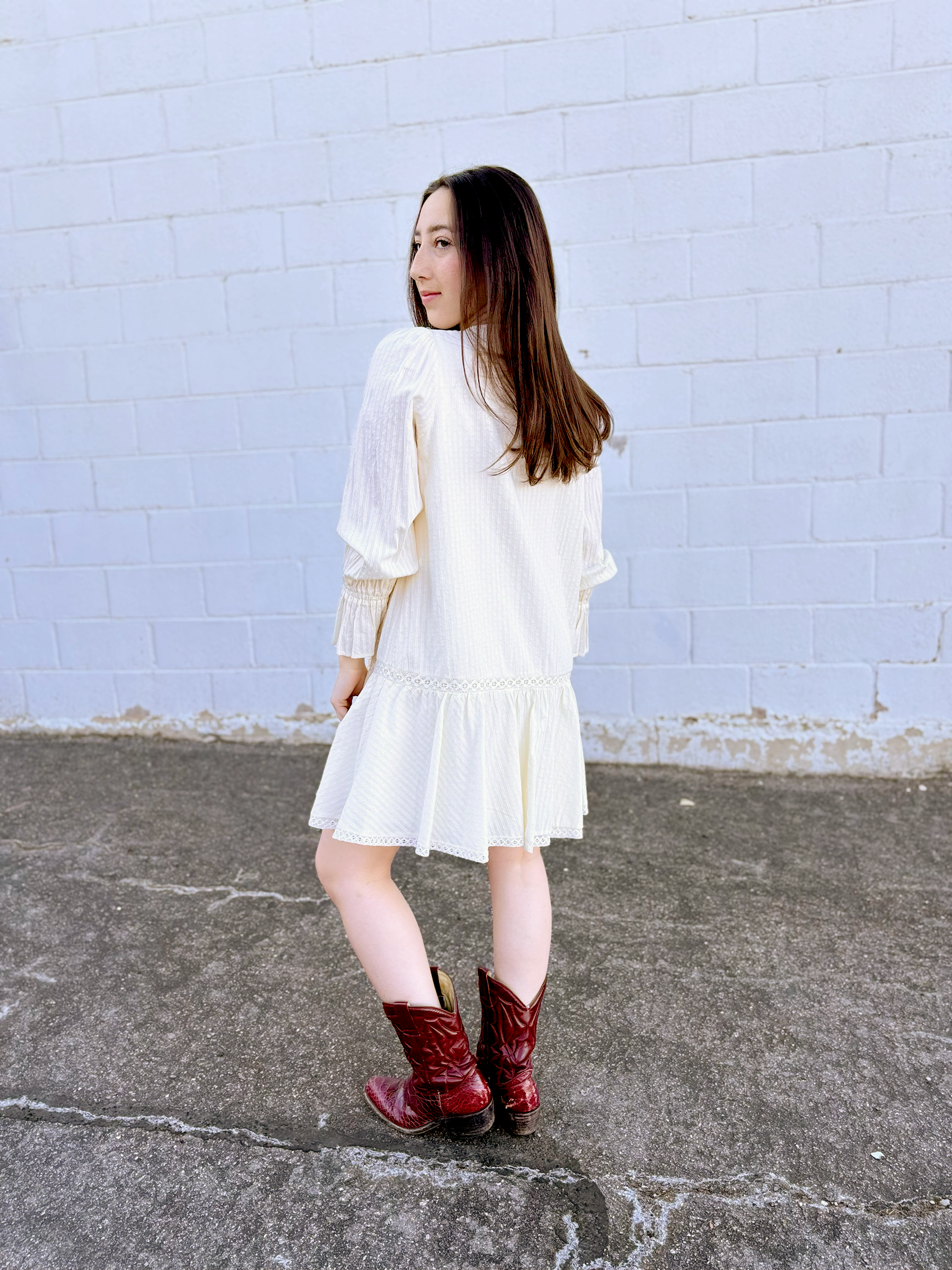 Ivory long sleeve short dress with lace details and a drop waist 