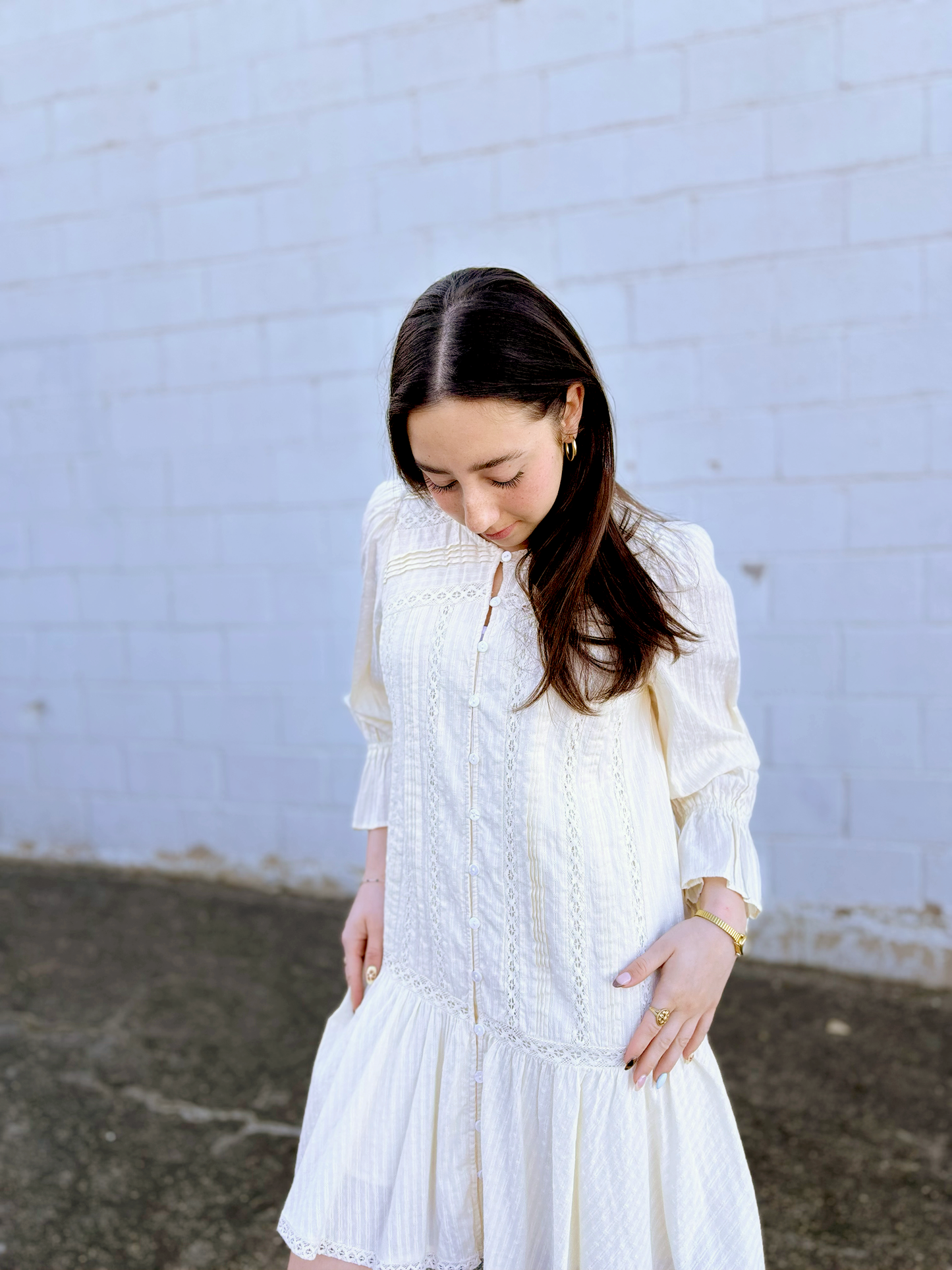 Ivory long sleeve short dress with lace details and a drop waist 