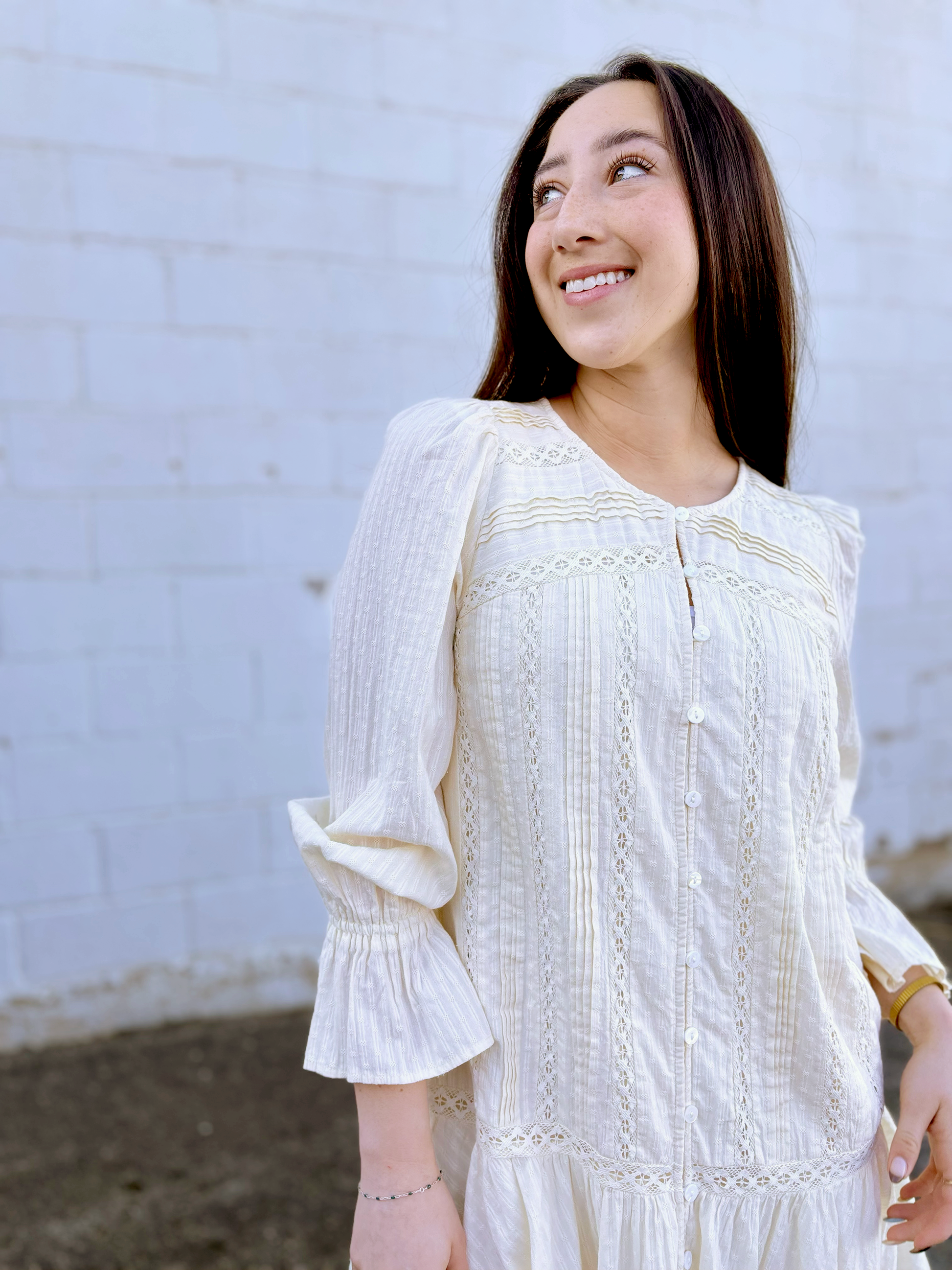 Ivory long sleeve short dress with lace details and a drop waist 