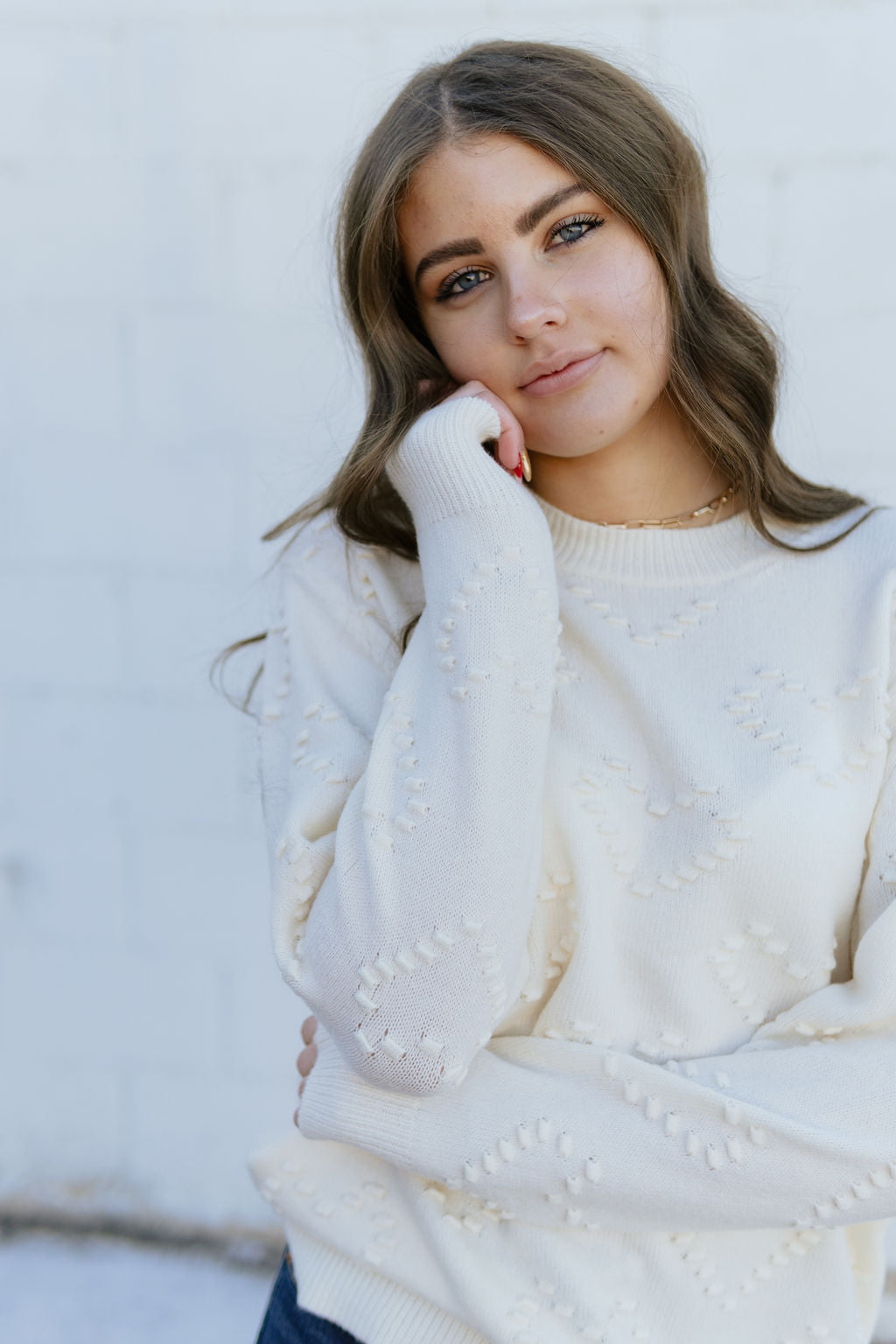 Ivory Sweater with embossed heart pattern over top