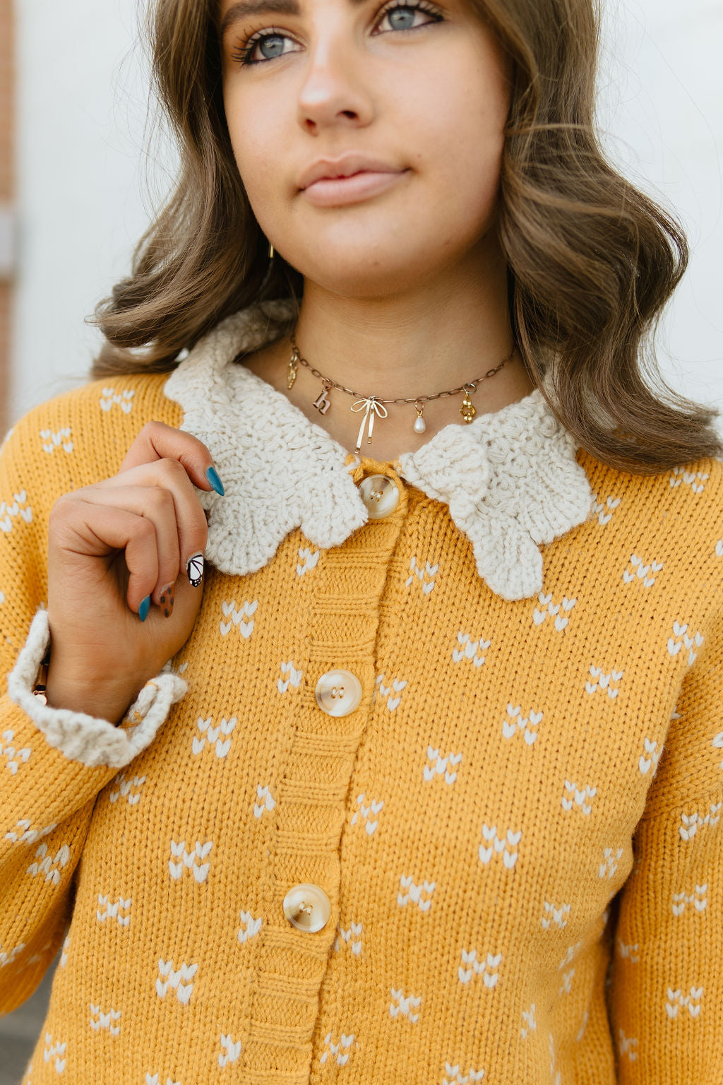 yellow button up sweater with scalloped knit collar and sleeves