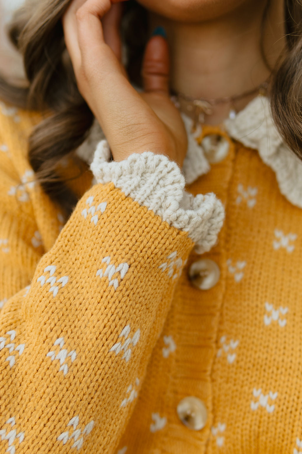 yellow button up sweater with scalloped knit collar and sleeves