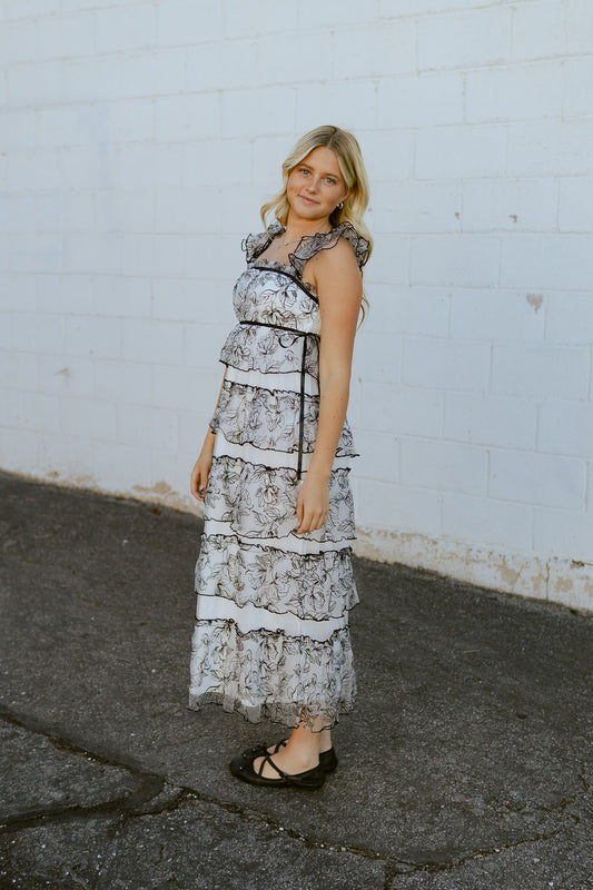 White dress with black lace over top