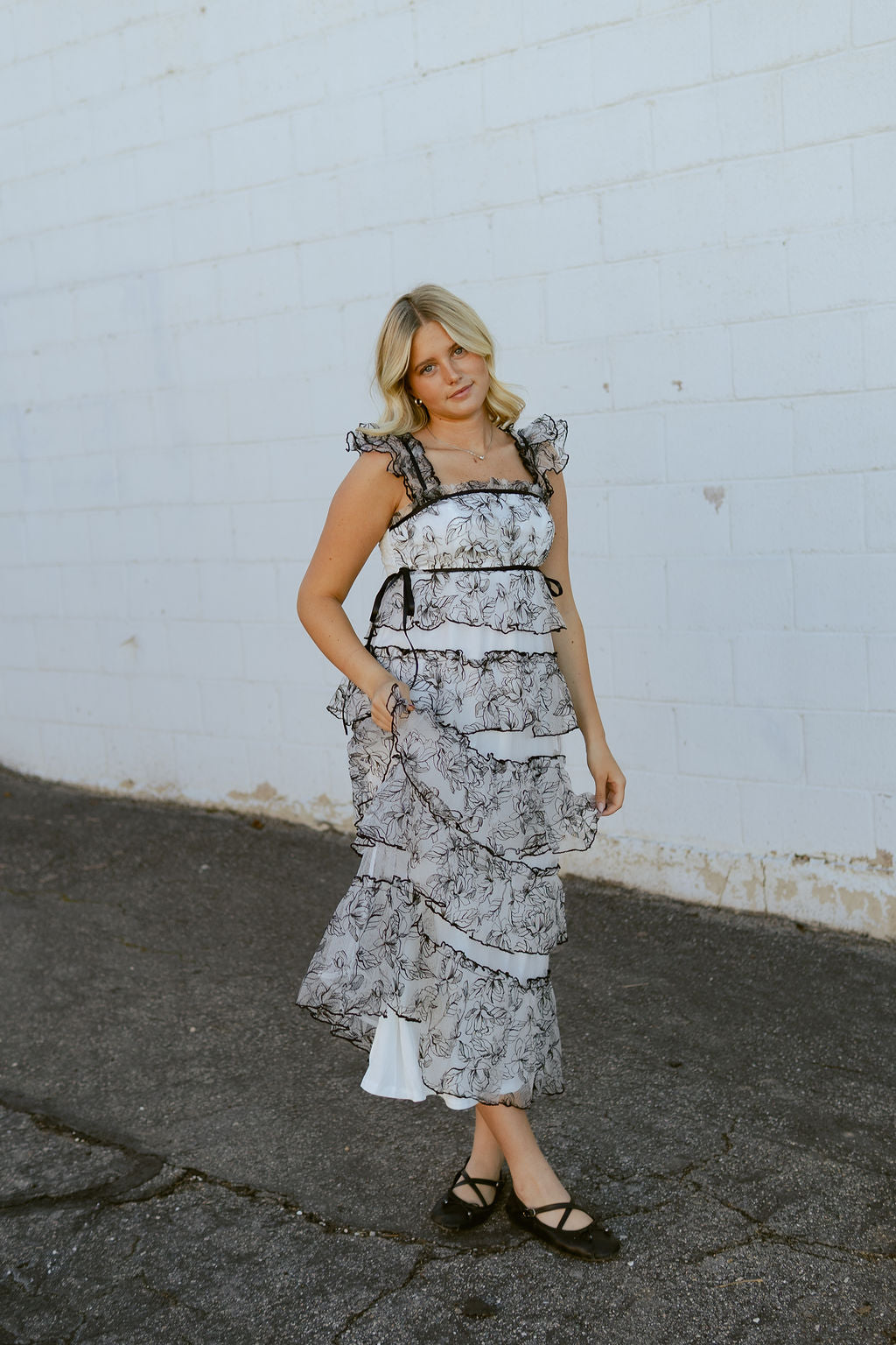 White dress with black lace over top