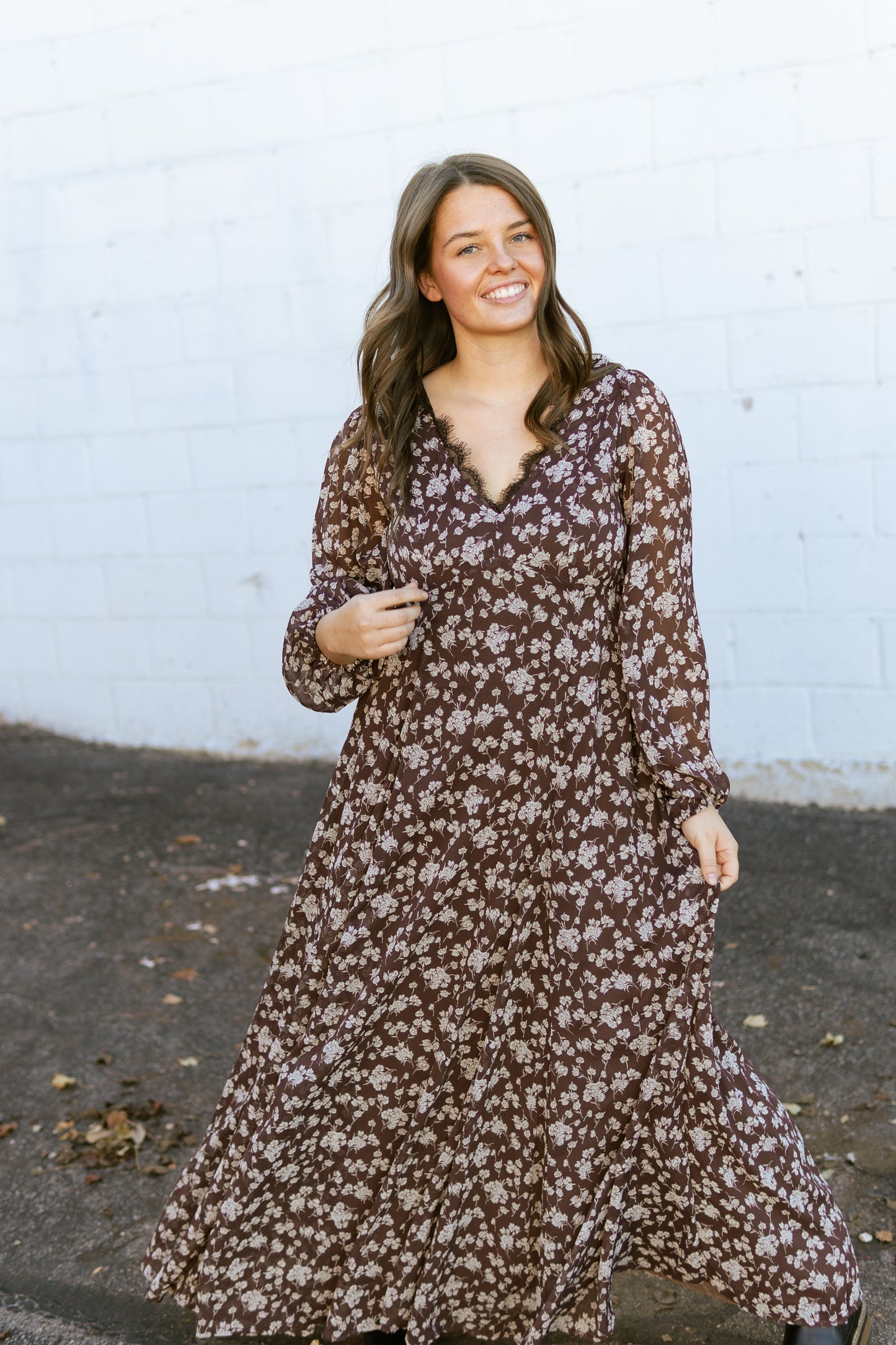 brown floral v-neck dress with lace detail along the neck line