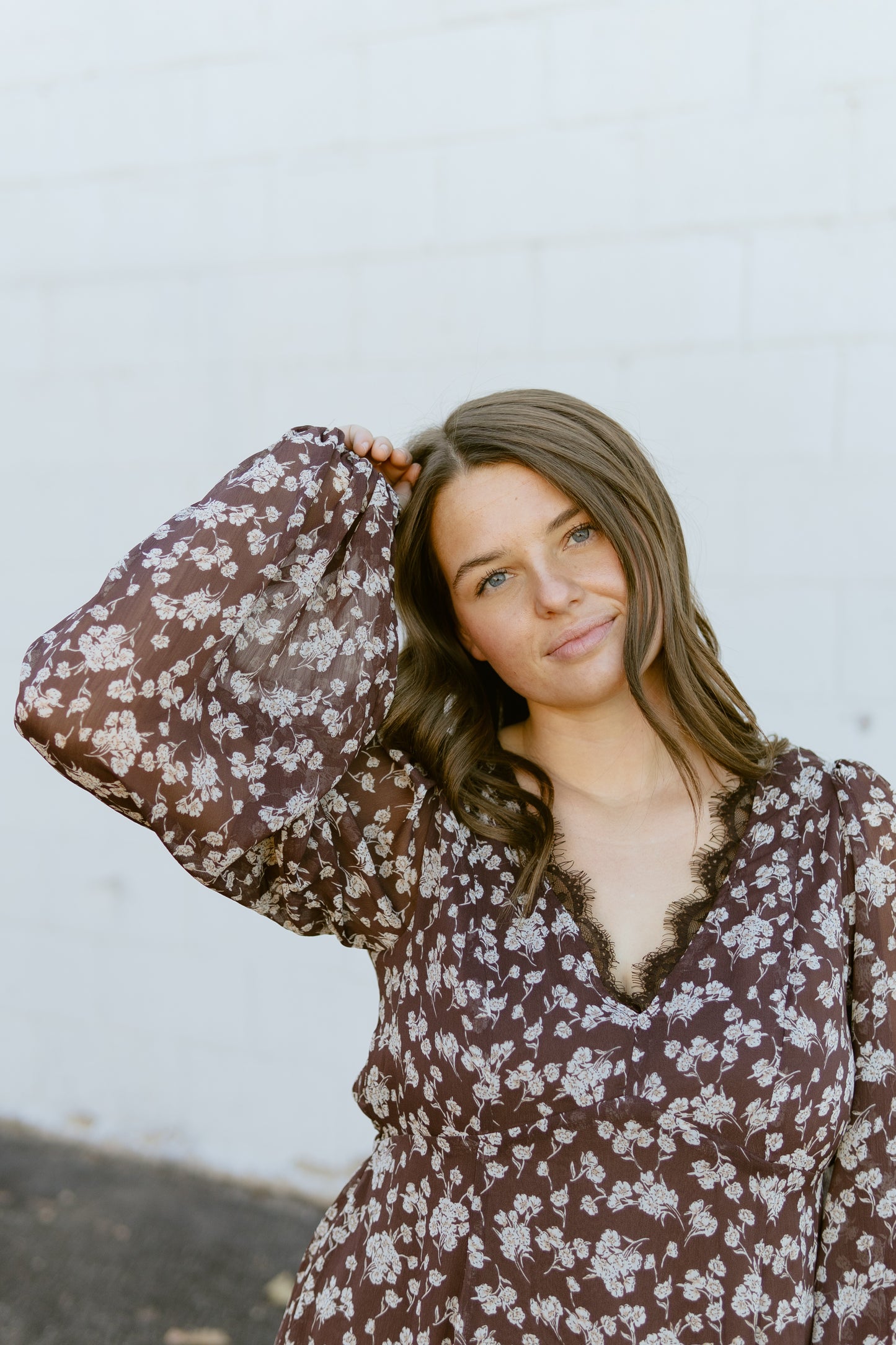 brown floral v-neck dress with lace detail along the neck line