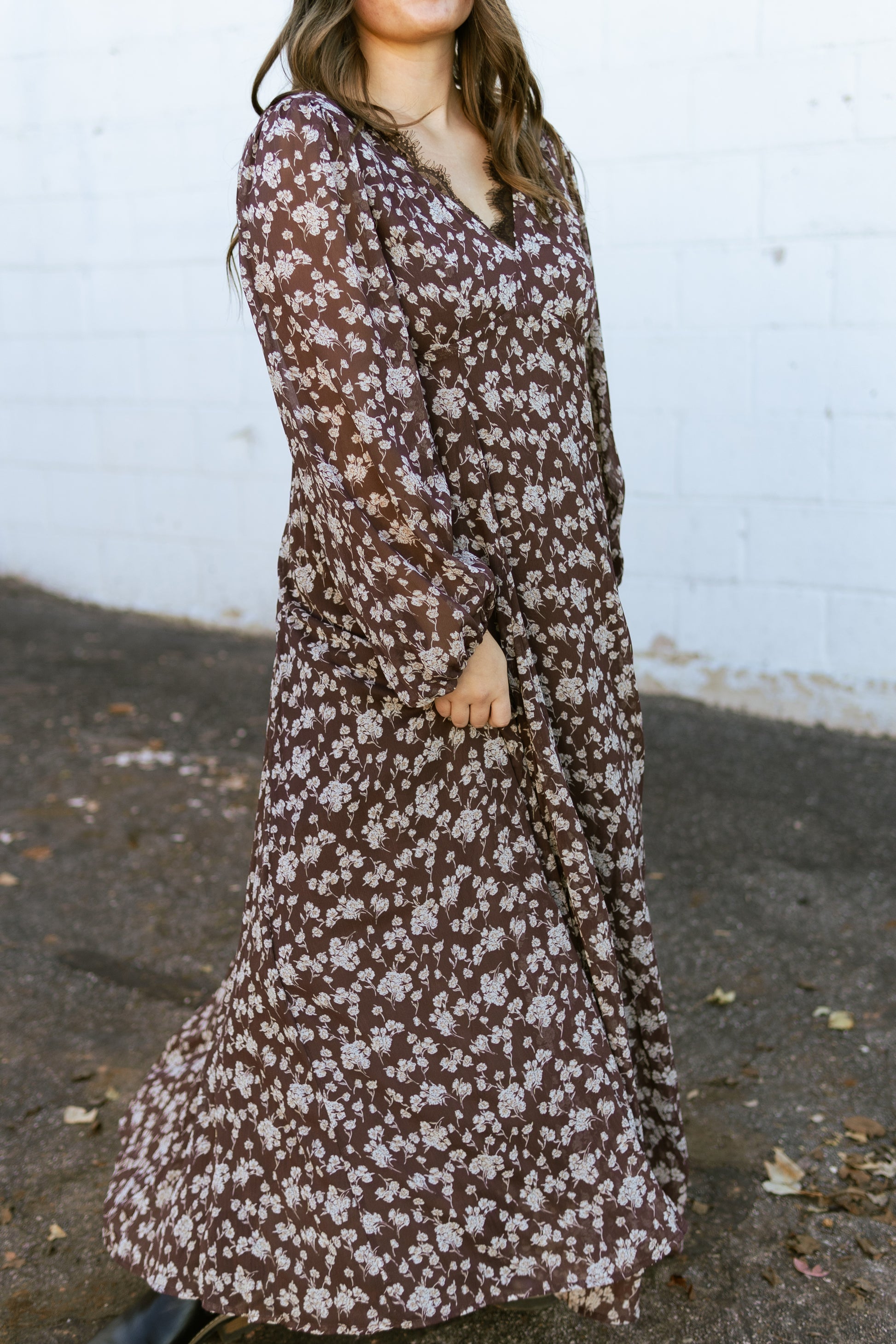 brown floral v-neck dress with lace detail along the neck line