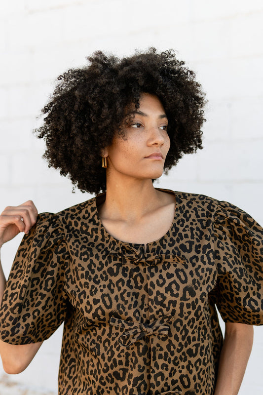 Leopard print top with three bows down front and puff sleeves