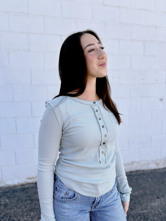 Sage colored long sleeved ribbed tee with buttons up the front