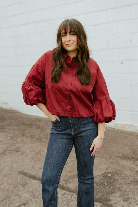 Deep red top with balloon sleeves and a slight crop
