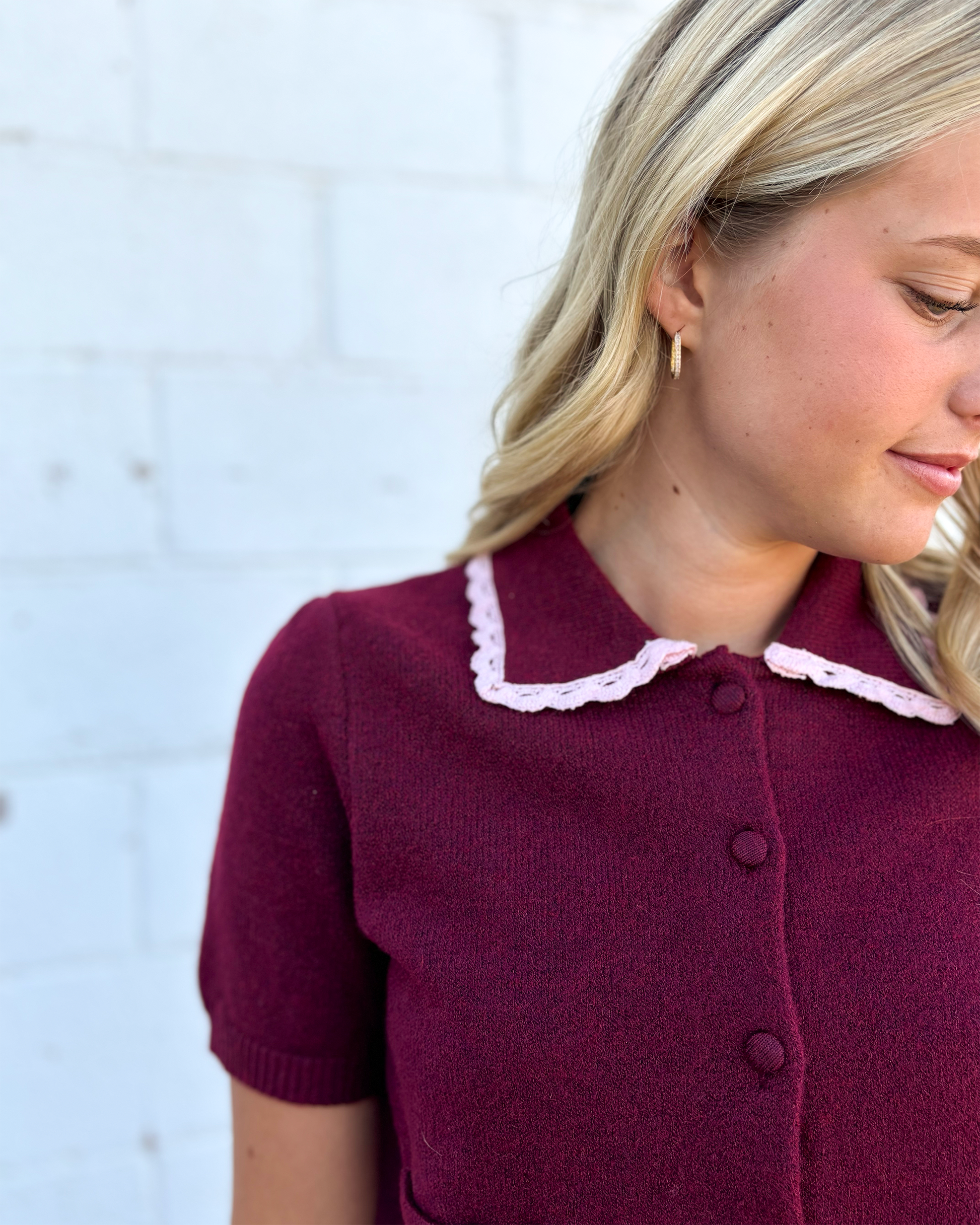 cute maroon button up cropped sweater with pink lace trimming the collar