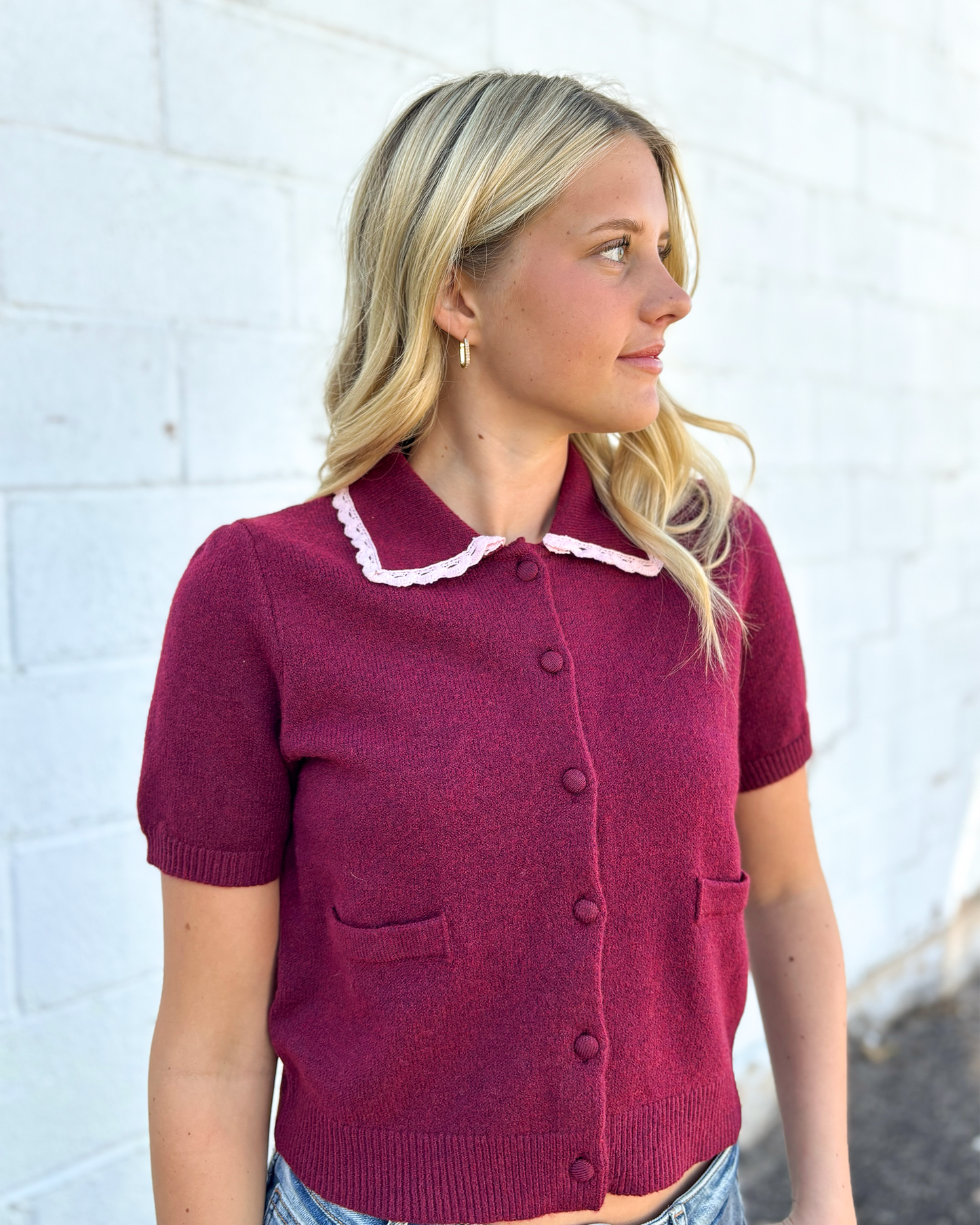 cute maroon button up cropped sweater with pink lace trimming the collar
