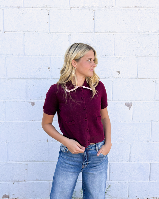 cute maroon button up cropped sweater with pink lace trimming the collar