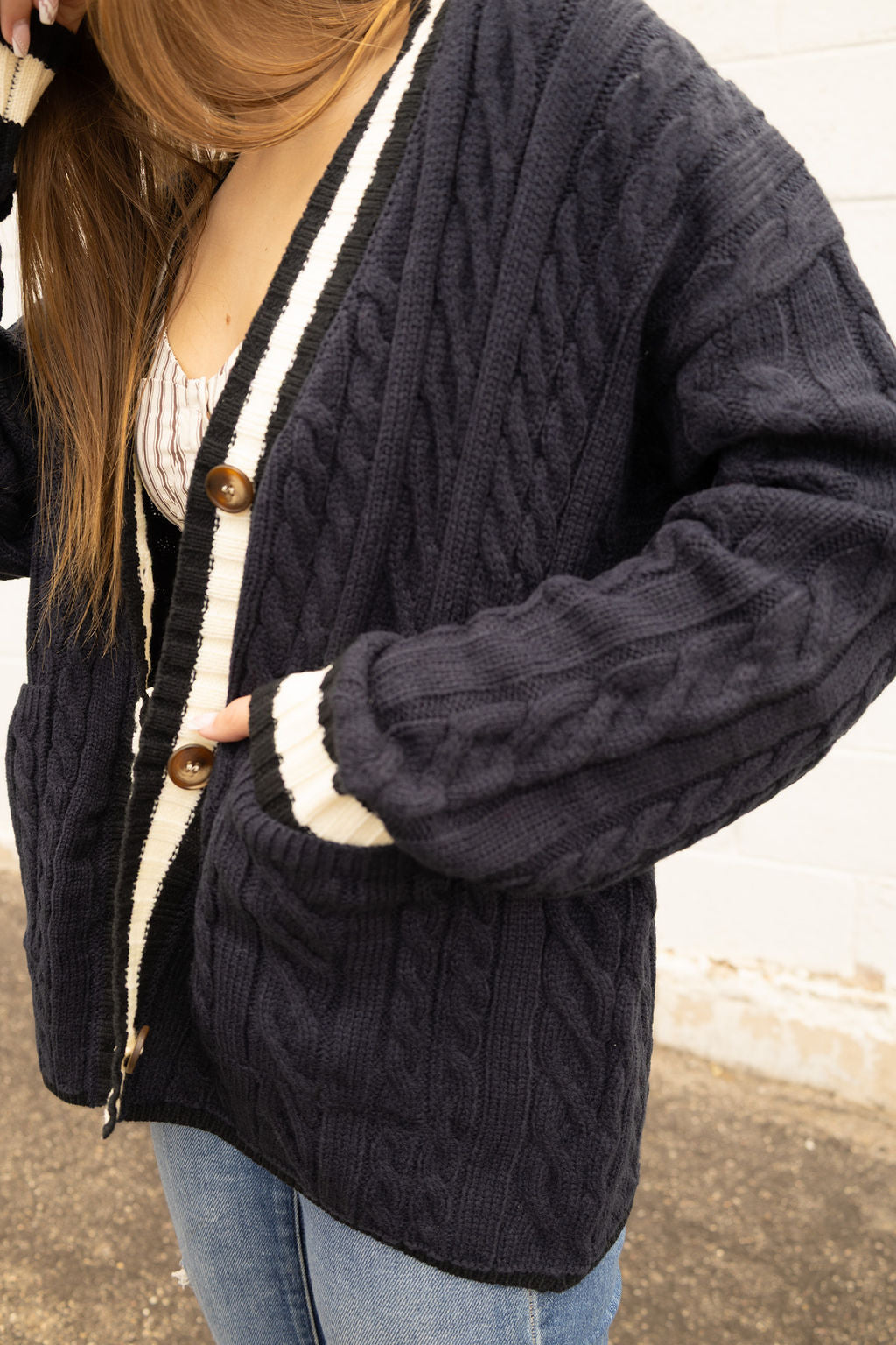 Navy cardigan with white stripe along front and sleeves