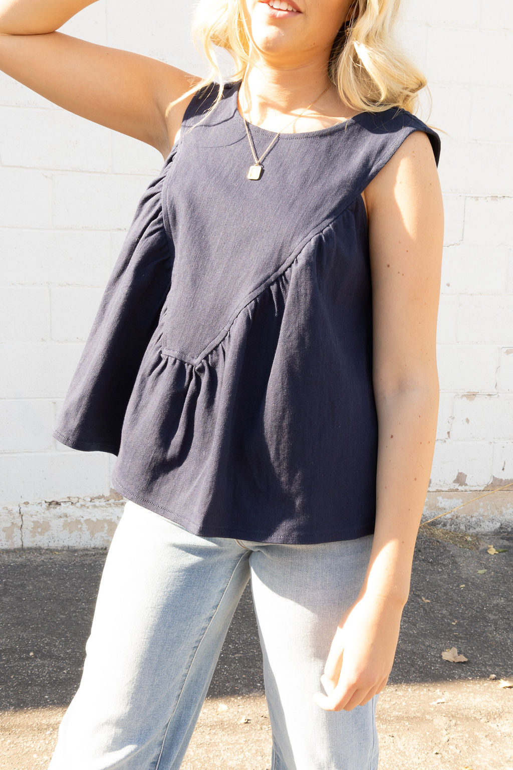 Navy sleeveless top with rusched V