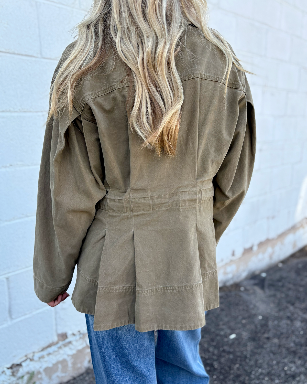 Olive jacket with cinched waist with pleats on the front and back