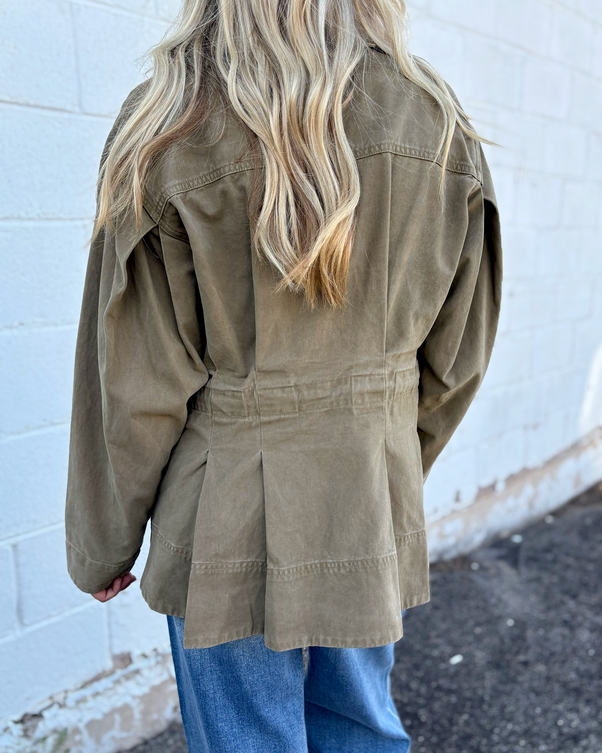 Olive jacket with cinched waist with pleats on the front and back