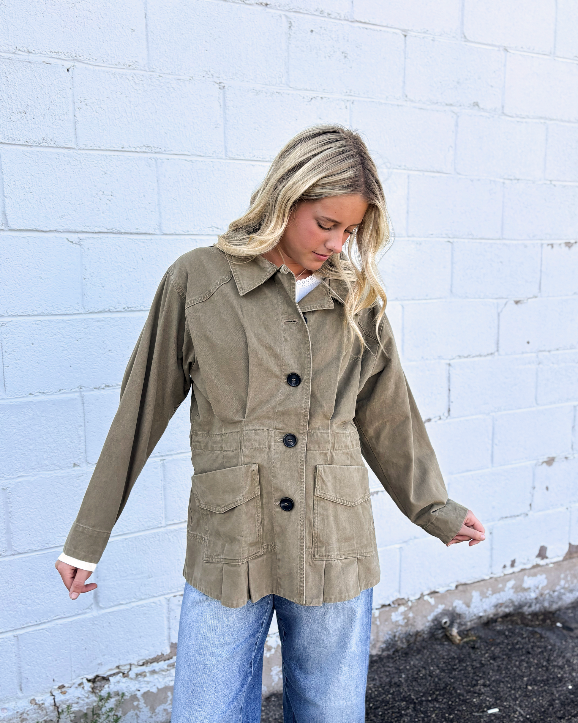 Olive jacket with cinched waist with pleats on the front and back