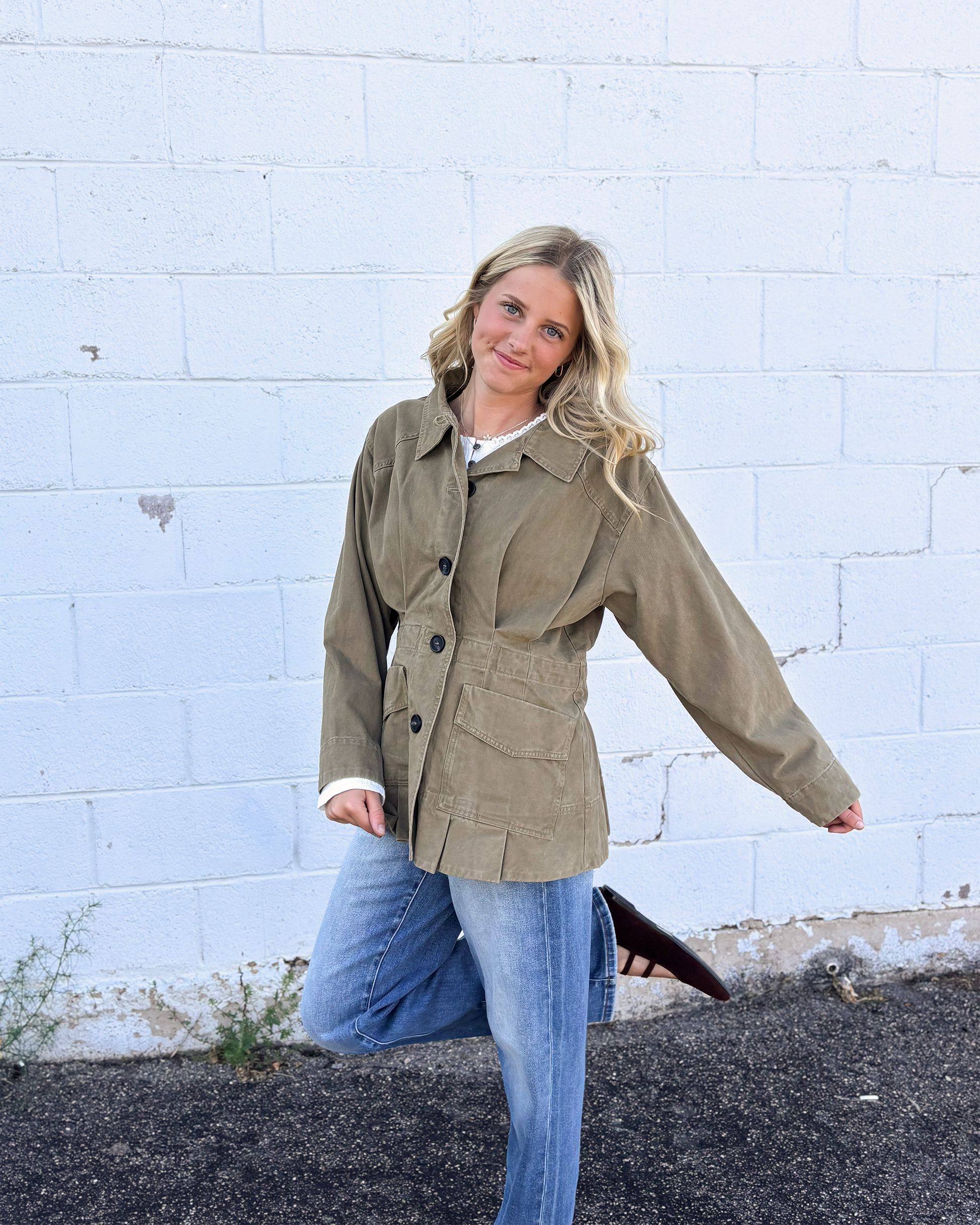 Olive jacket with cinched waist with pleats on the front and back