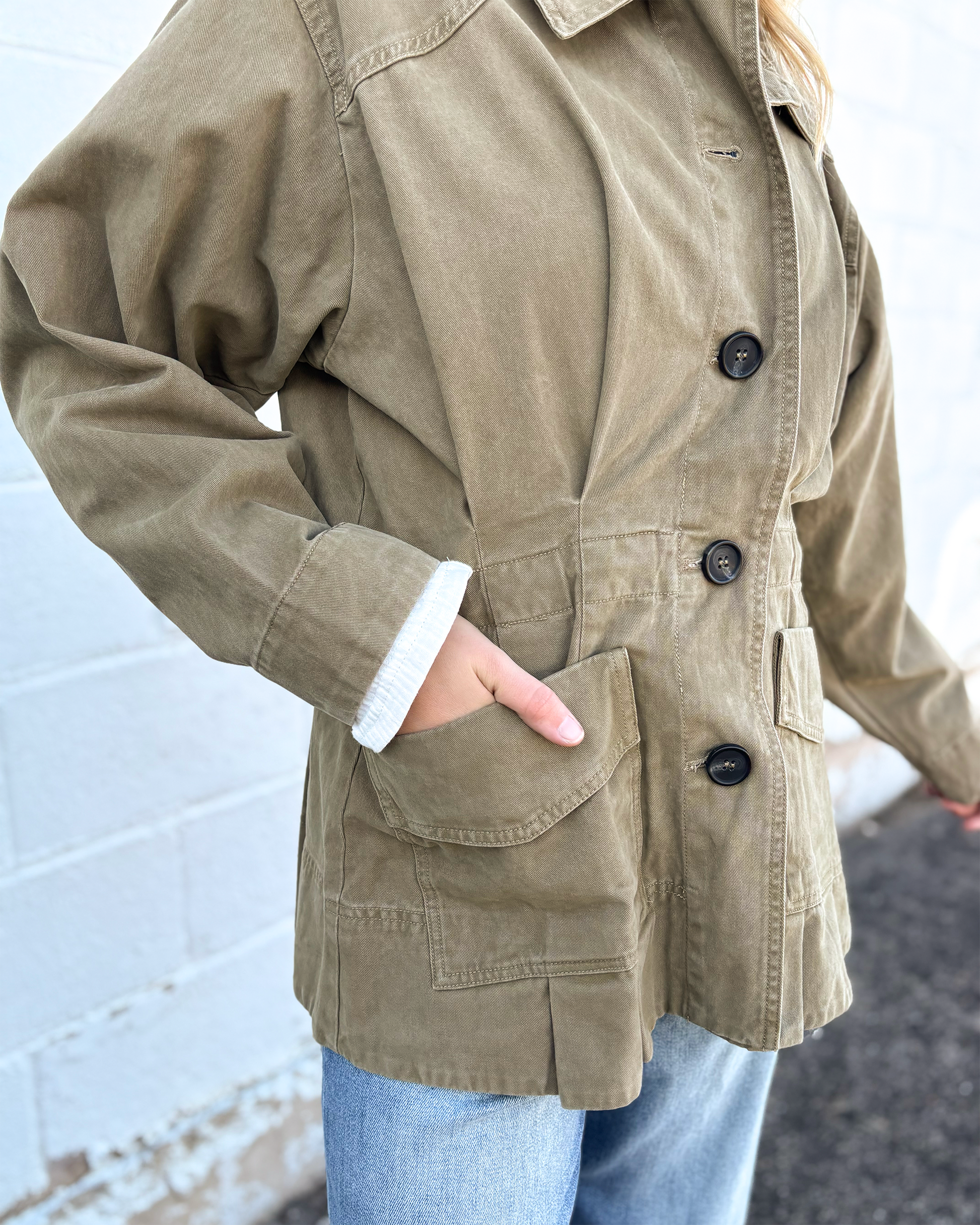 Olive jacket with cinched waist with pleats on the front and back