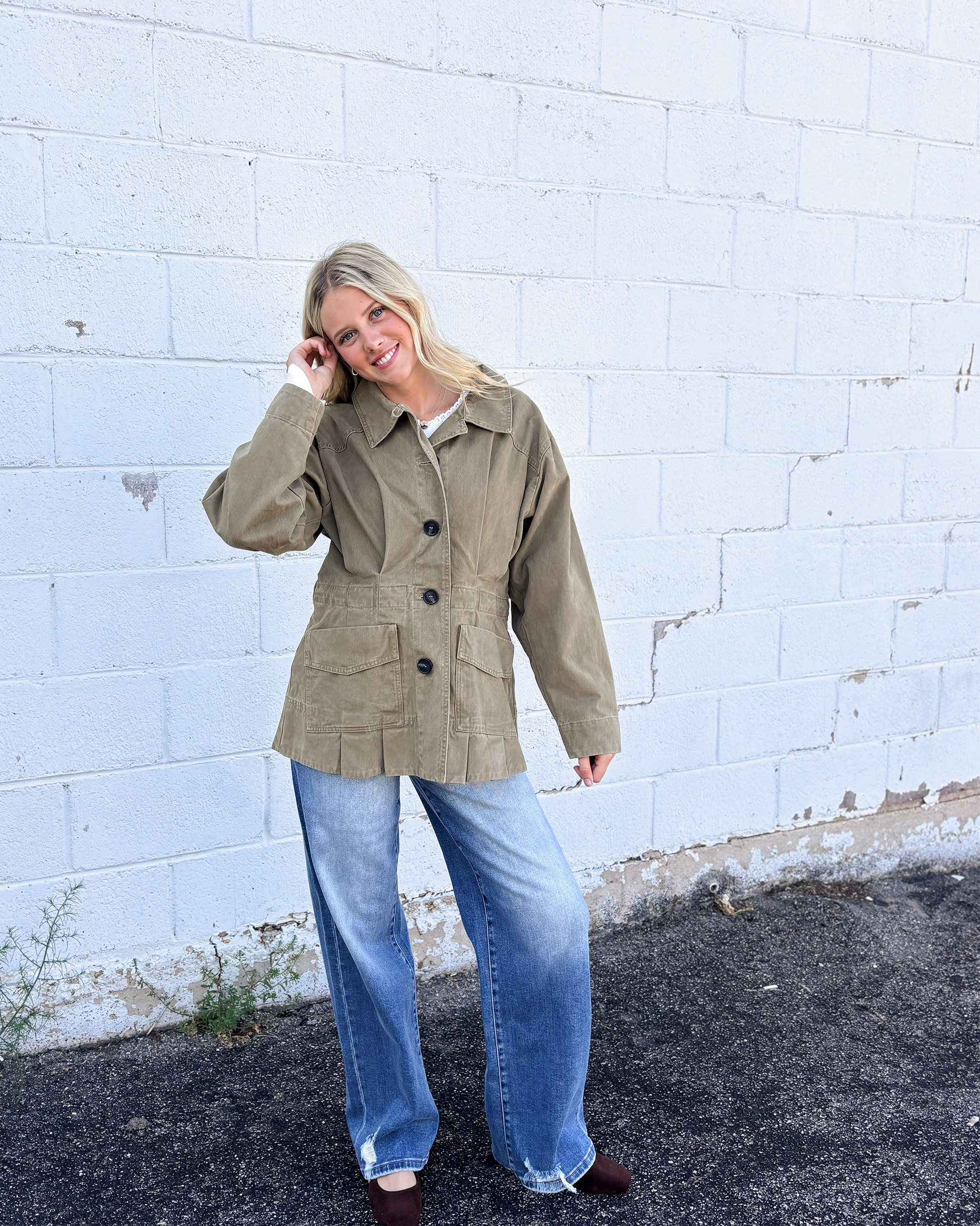 Olive jacket with cinched waist with pleats on the front and back
