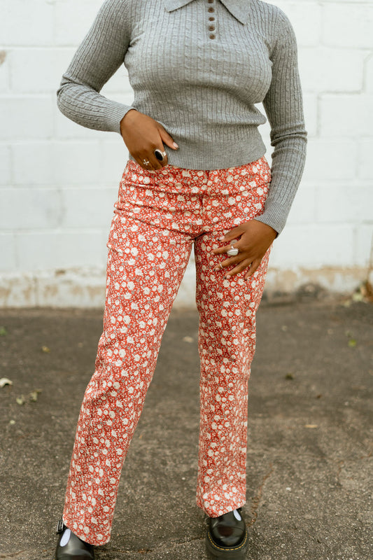 Orange pants with white floral pattern