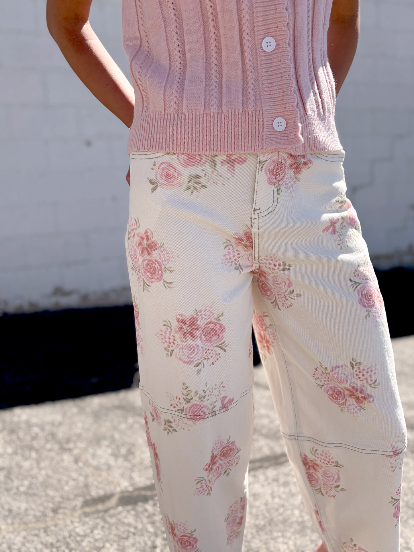 Ivory jeans with pink floral print all over and a slight barrel shape