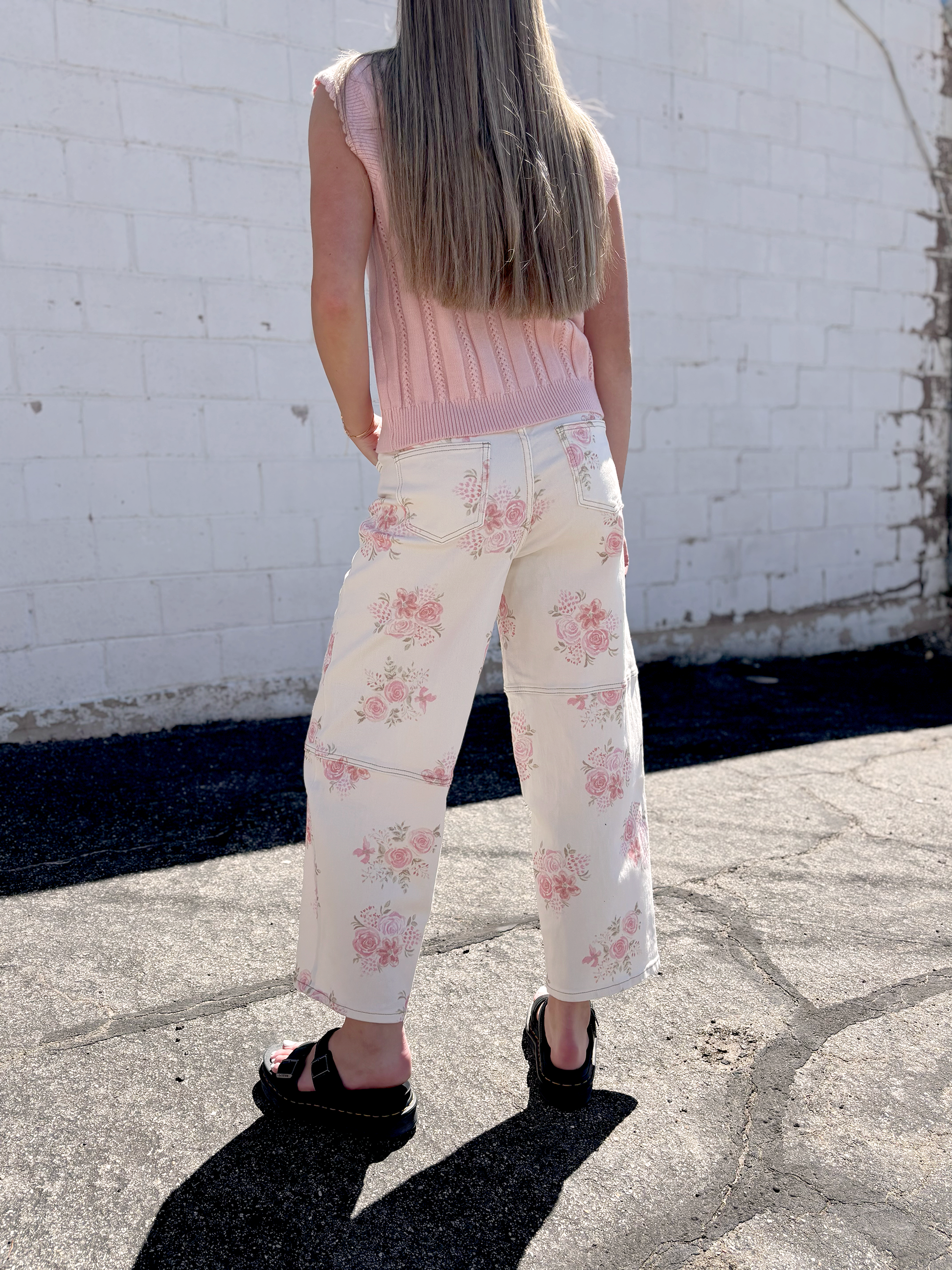 Ivory jeans with pink floral print all over and a slight barrel shape