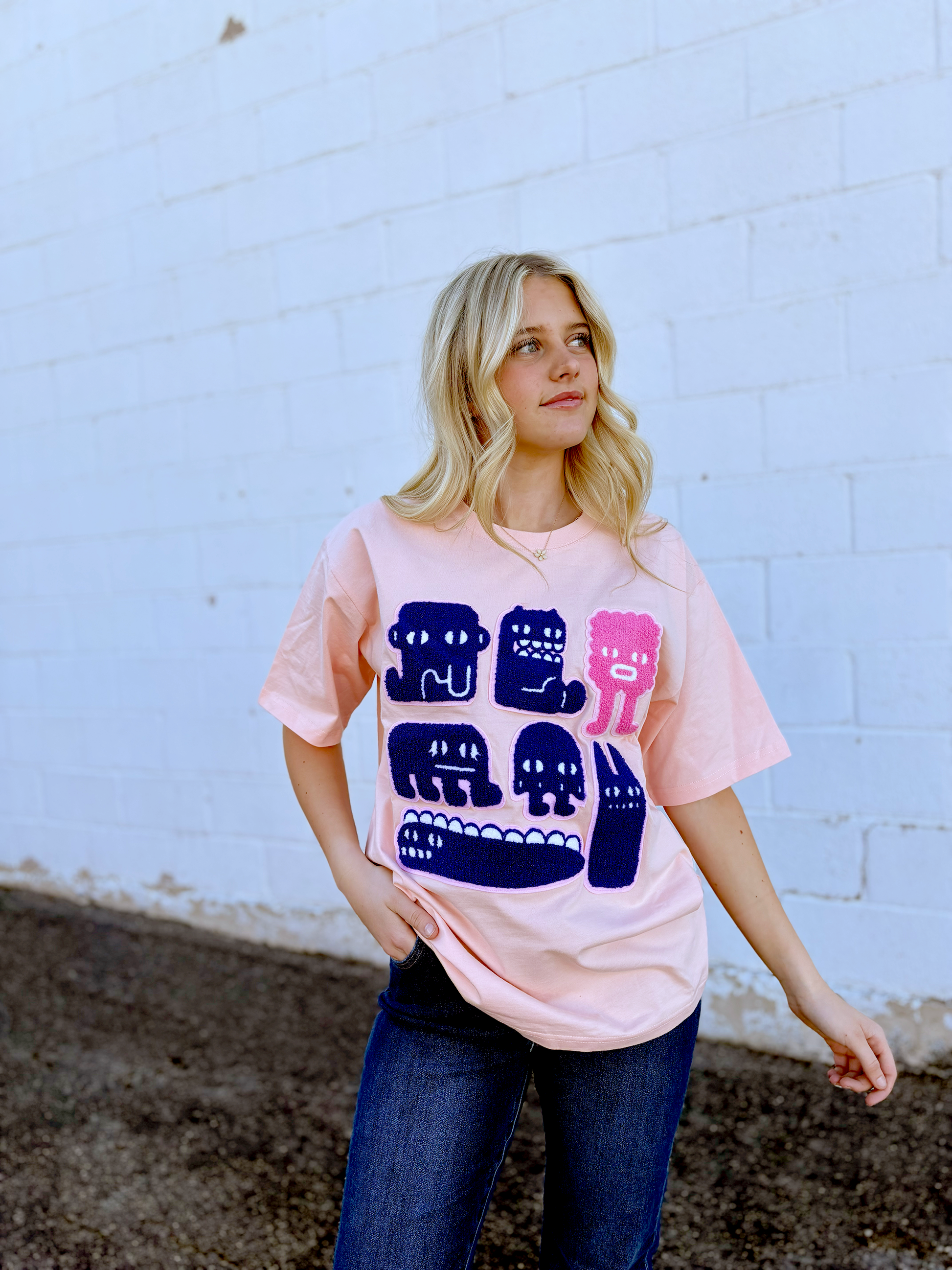 Pink Graphic tee with appliqué monsters on the front