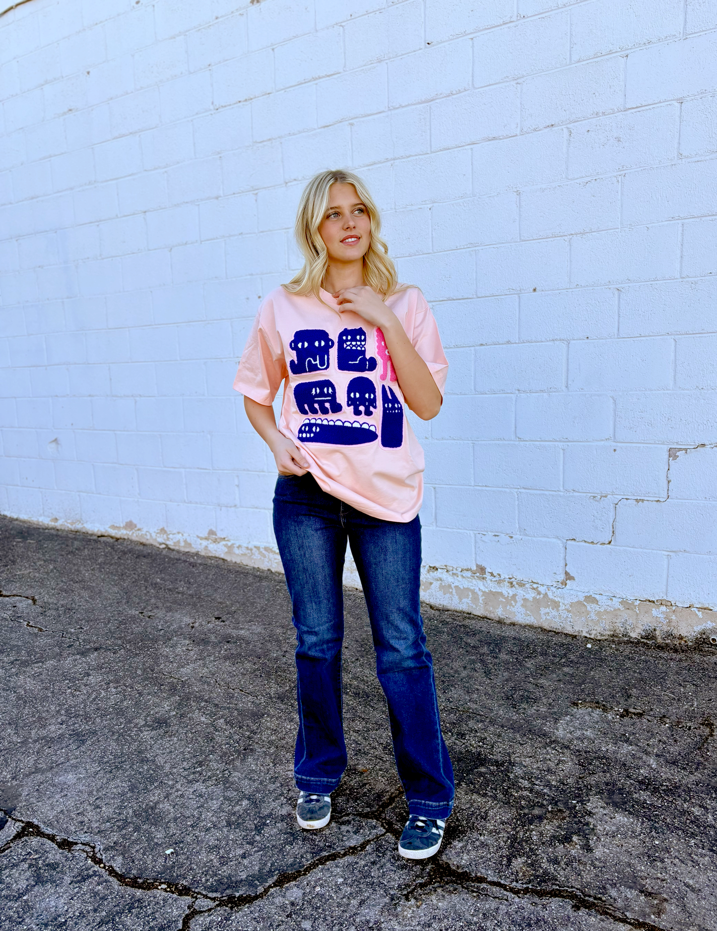 Pink Graphic tee with appliqué monsters on the front