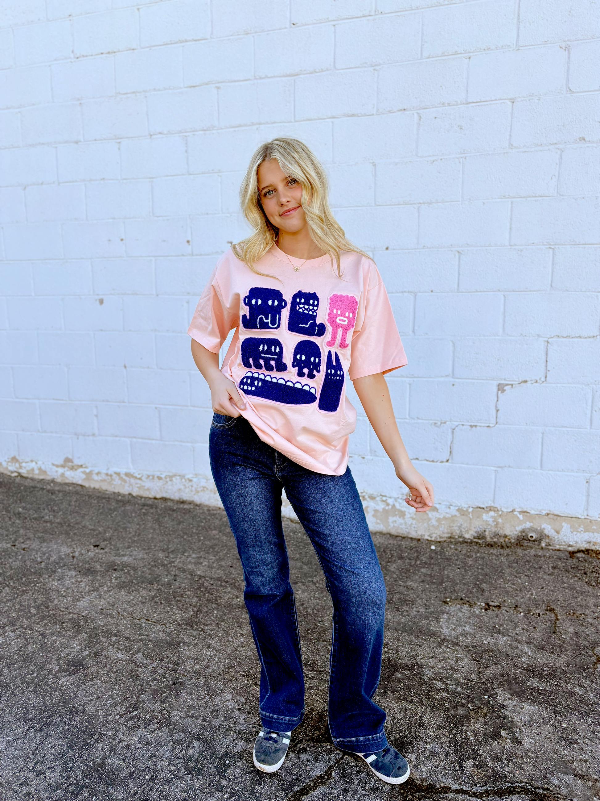 Pink Graphic tee with appliqué monsters on the front