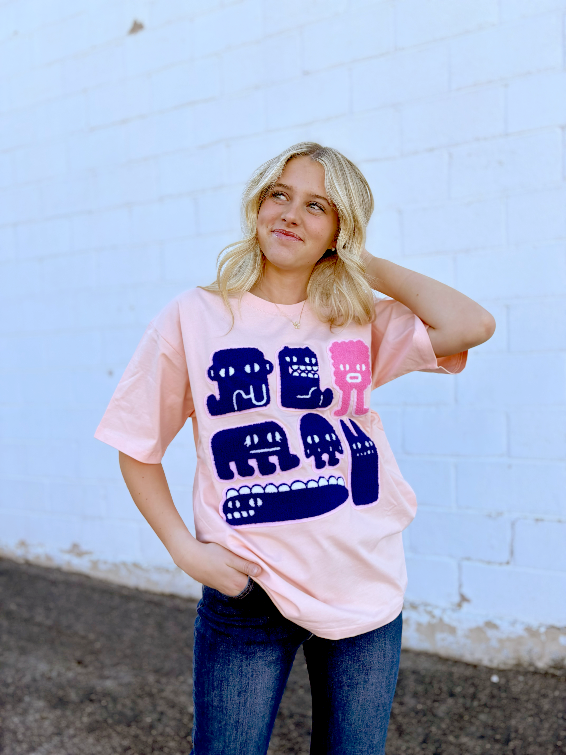 Pink Graphic tee with appliqué monsters on the front