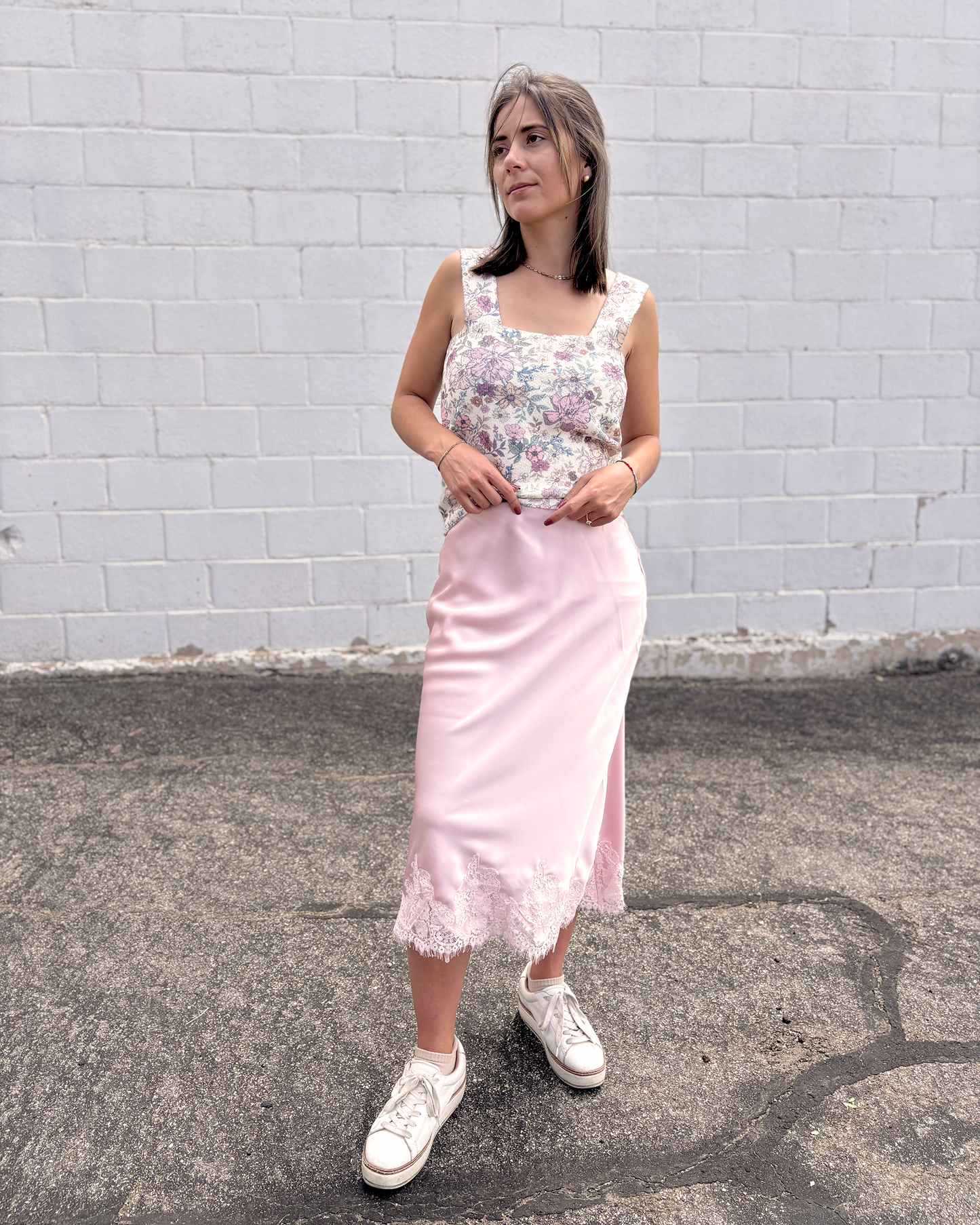 Pink satin skirt with lace trim along the bottom