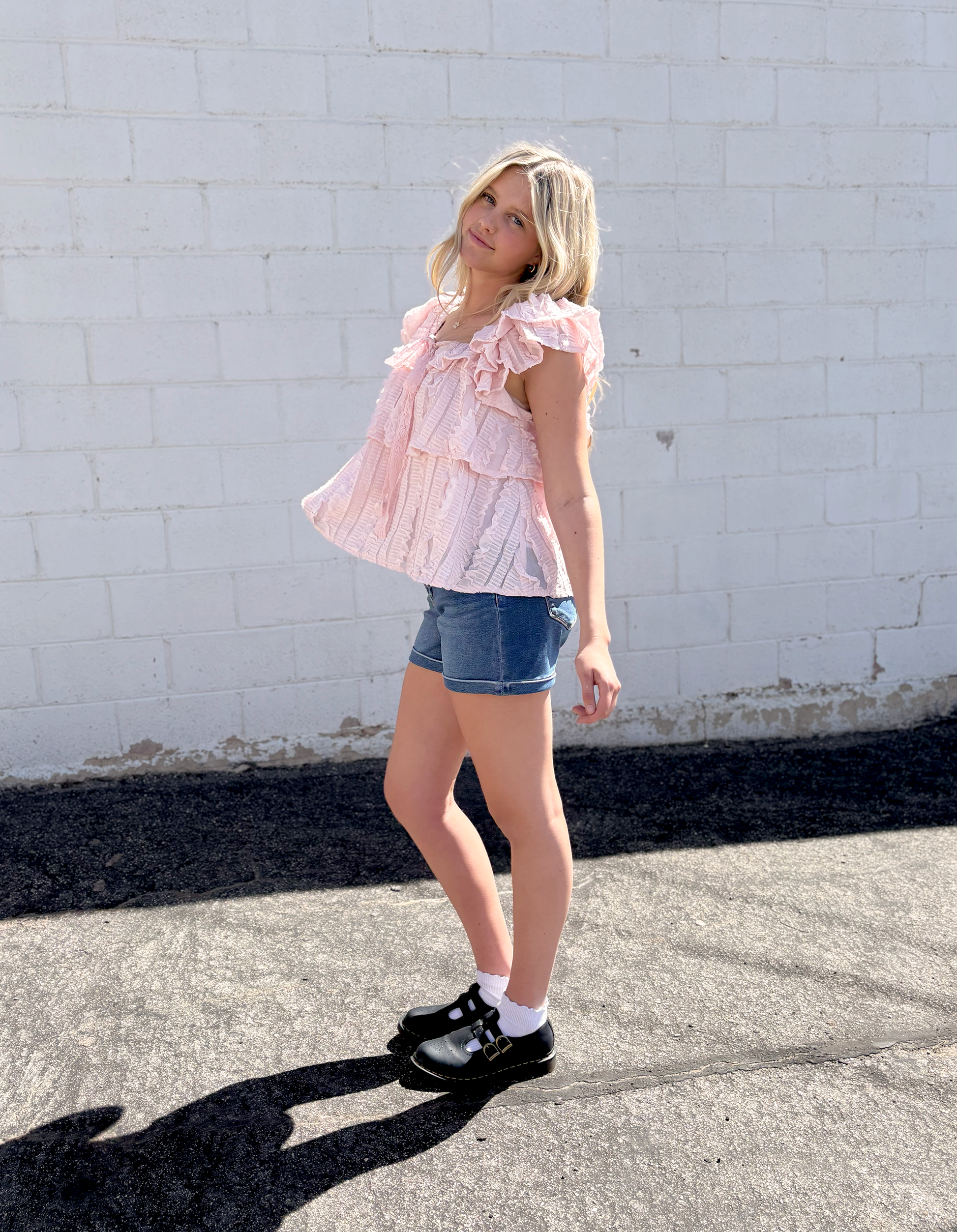 Cute pink ruffled top with tiered ruffles and bow