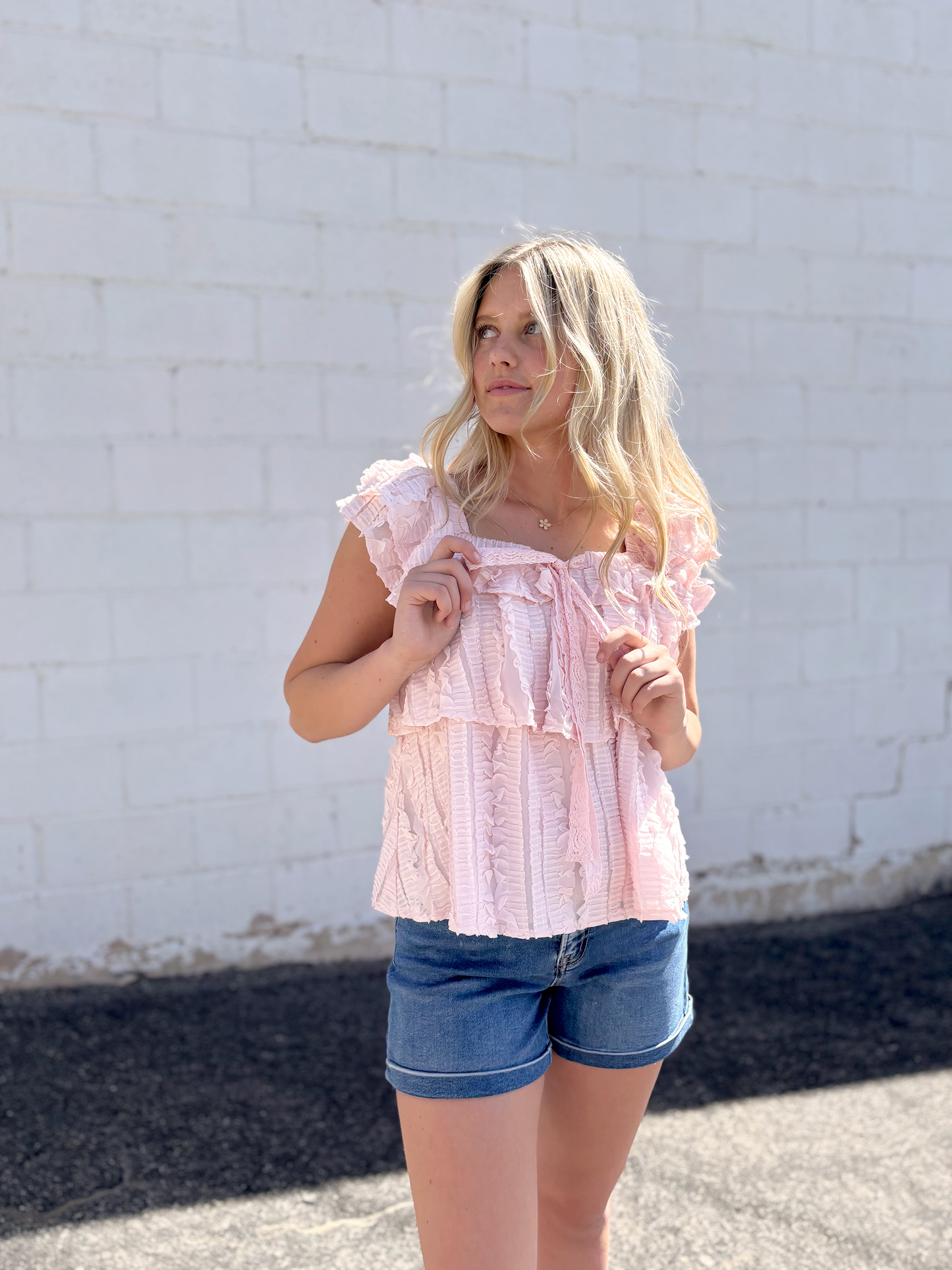 Cute pink ruffled top with tiered ruffles and bow
