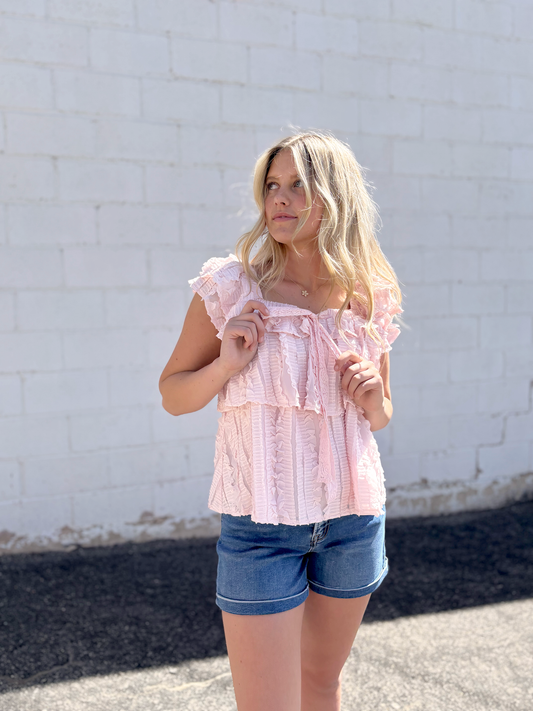 Cute pink ruffled top with tiered ruffles and bow