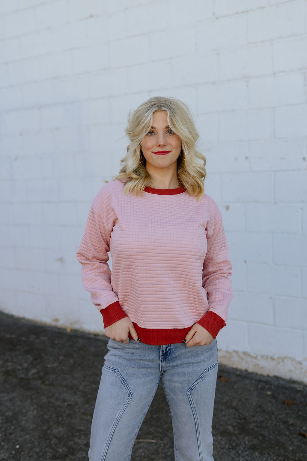 pink quilted sweater with maroon trim
