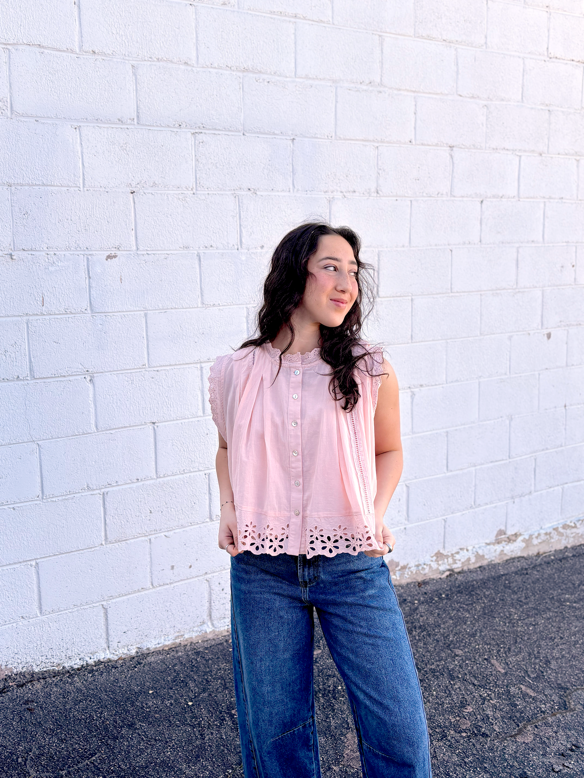Cute light pink A-symmetrical top with buttons up the front and large lace trim along the bottom