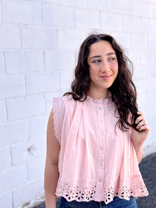 Cute light pink A-symmetrical top with buttons up the front and large lace trim along the bottom