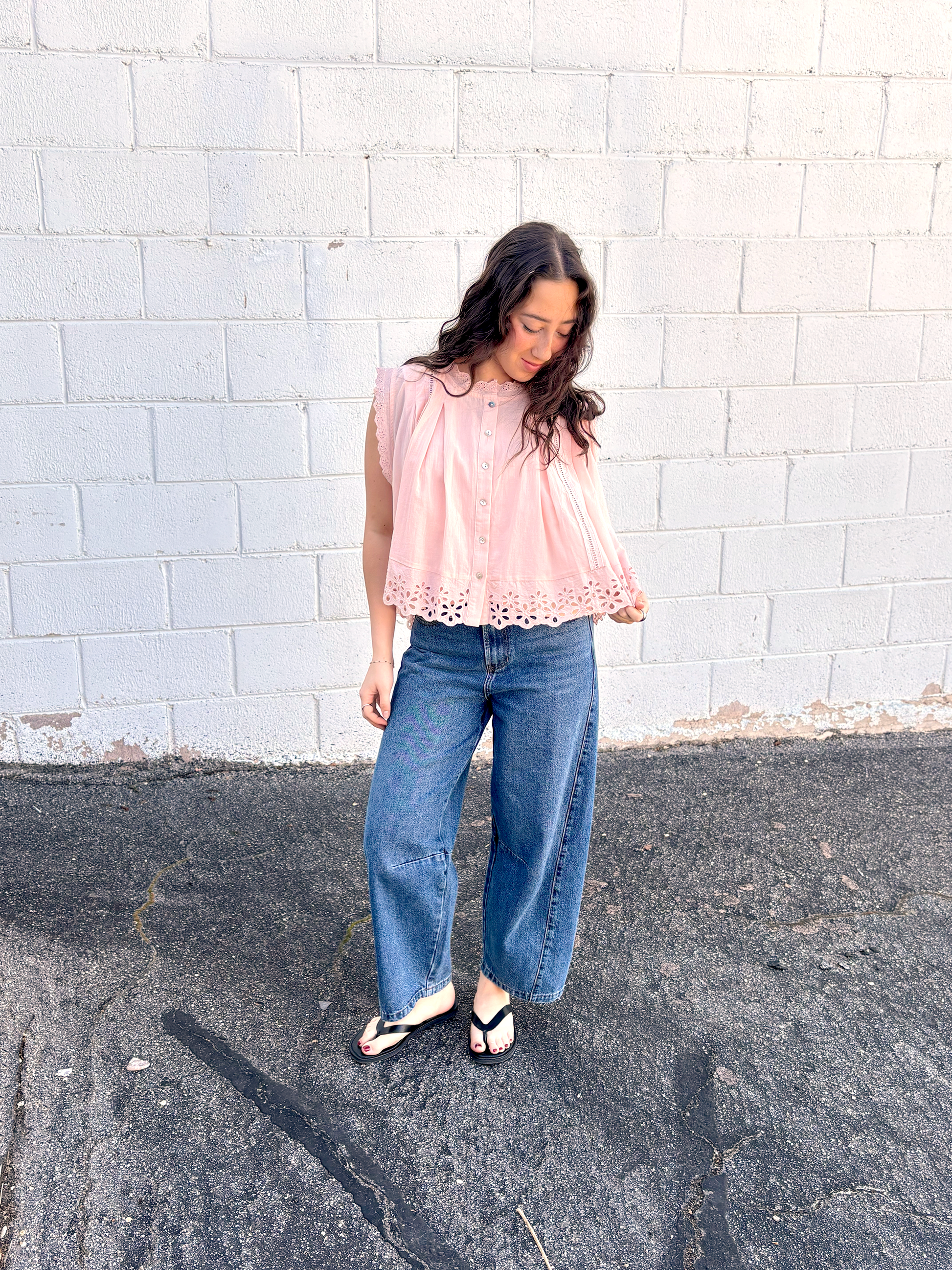 Cute light pink A-symmetrical top with buttons up the front and large lace trim along the bottom