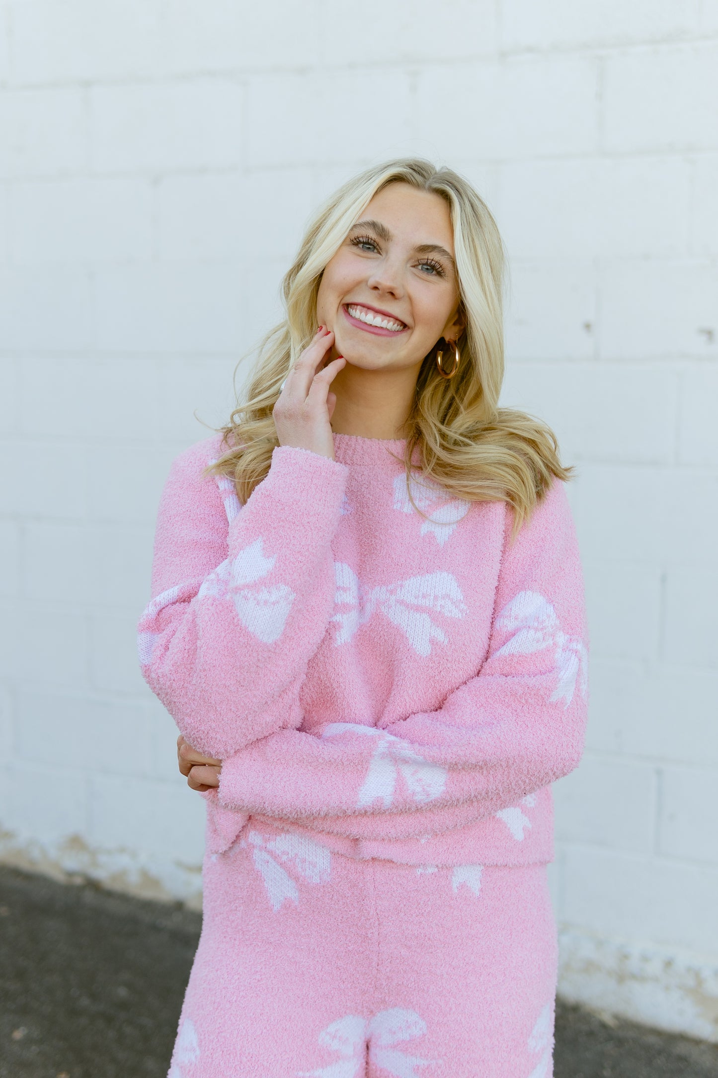 Pink set with sweater and pants with bow print