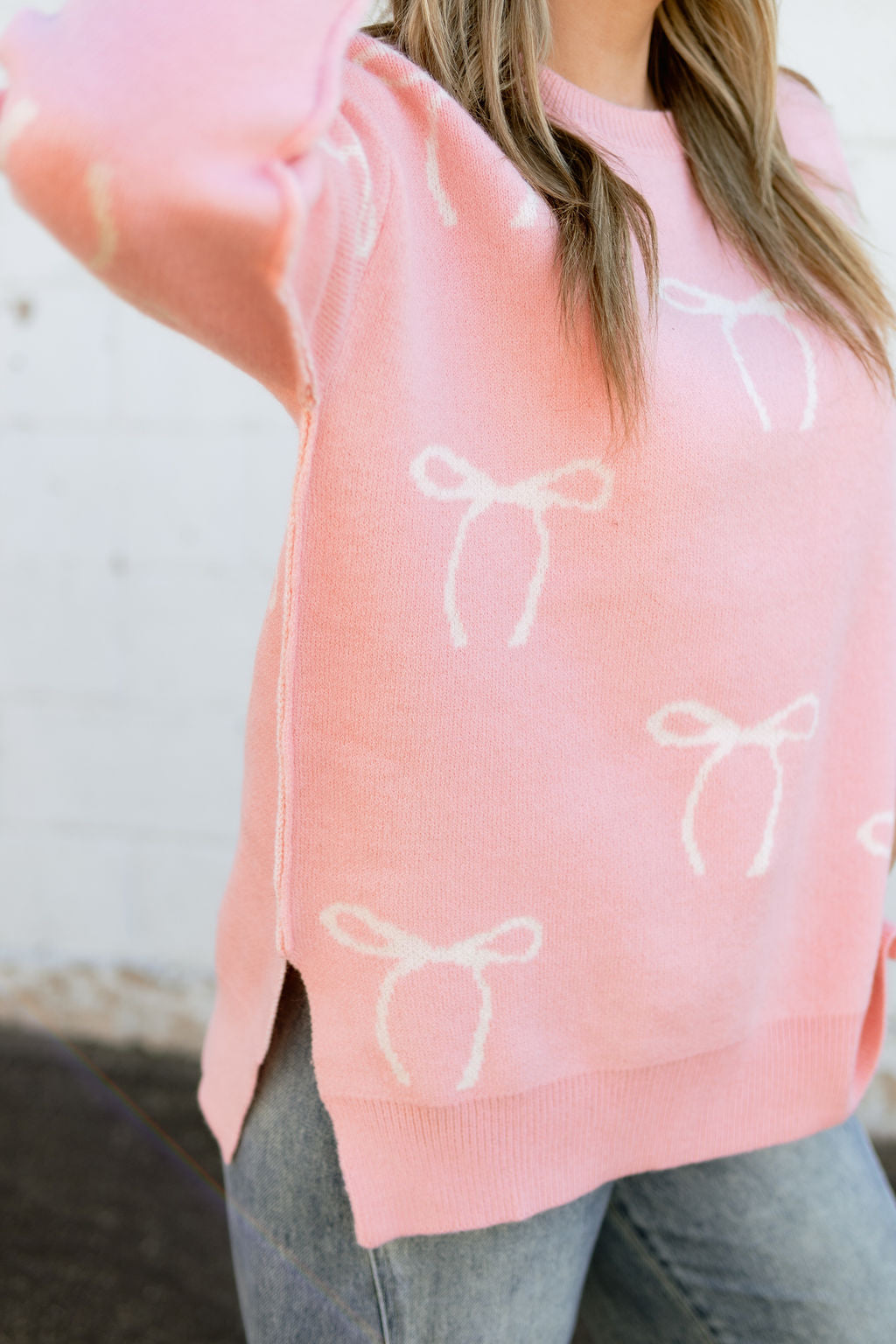 oversized pink sweater with small bow print all over