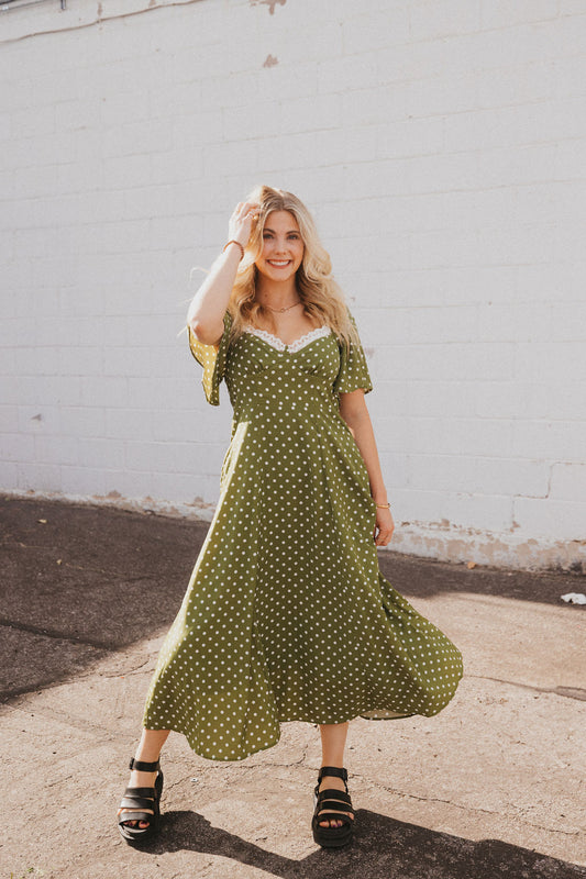 olive green dress with white polka dots and lace trim
